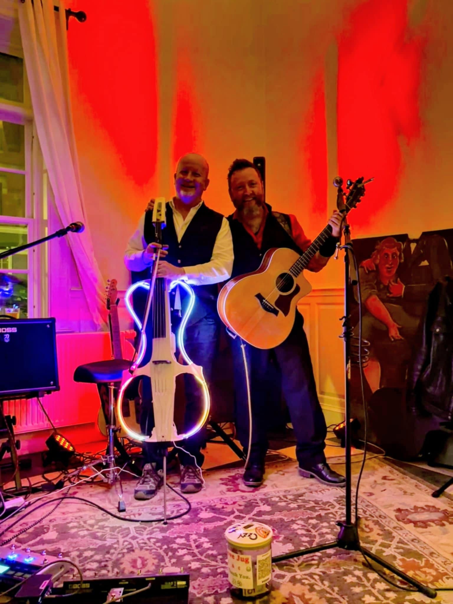 a group of men playing music in a room with red lights