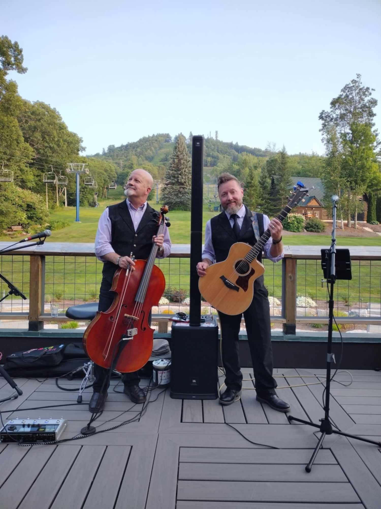 two men playing music on a deck