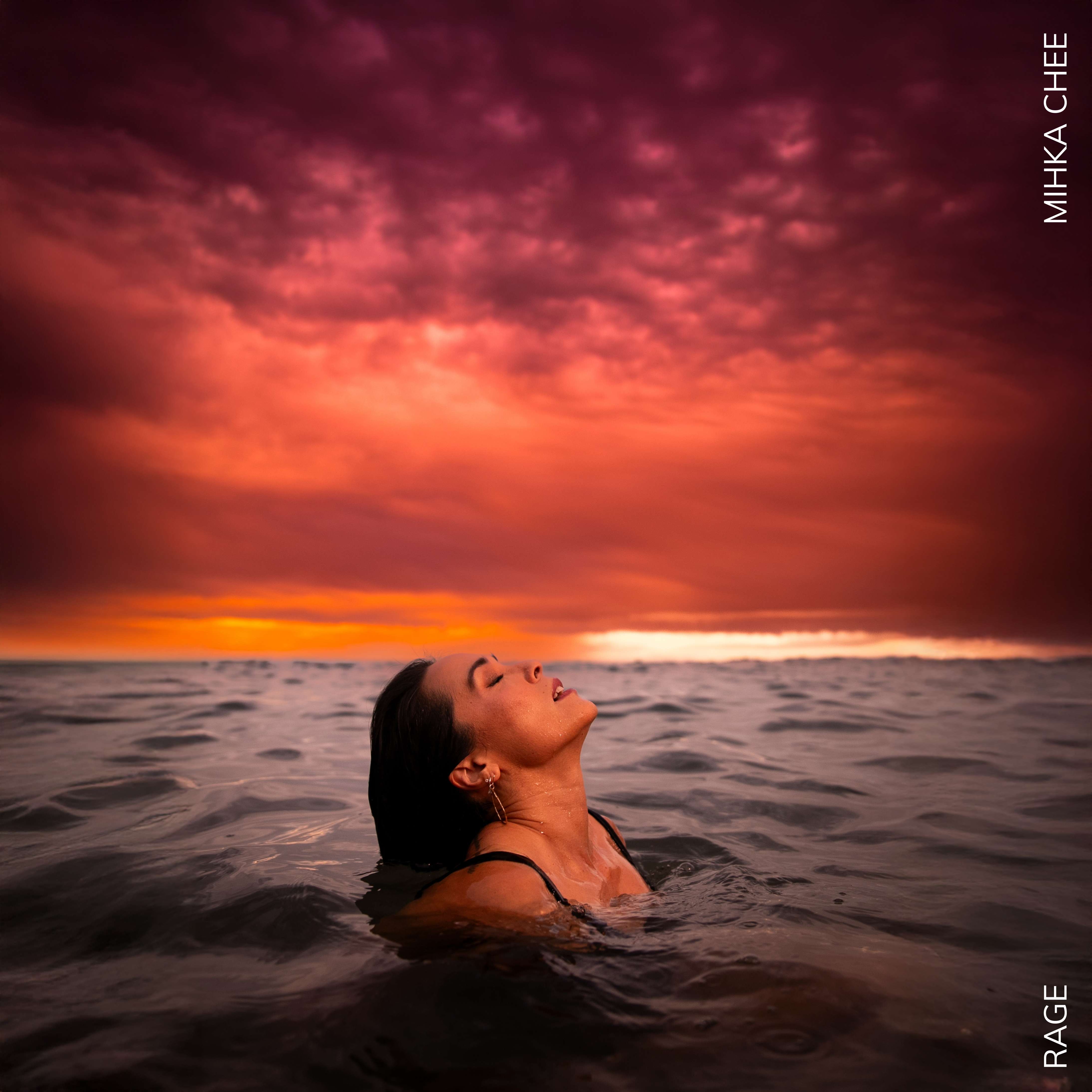 Mihka Chee - RAGE: a woman is floating in the ocean with her head up