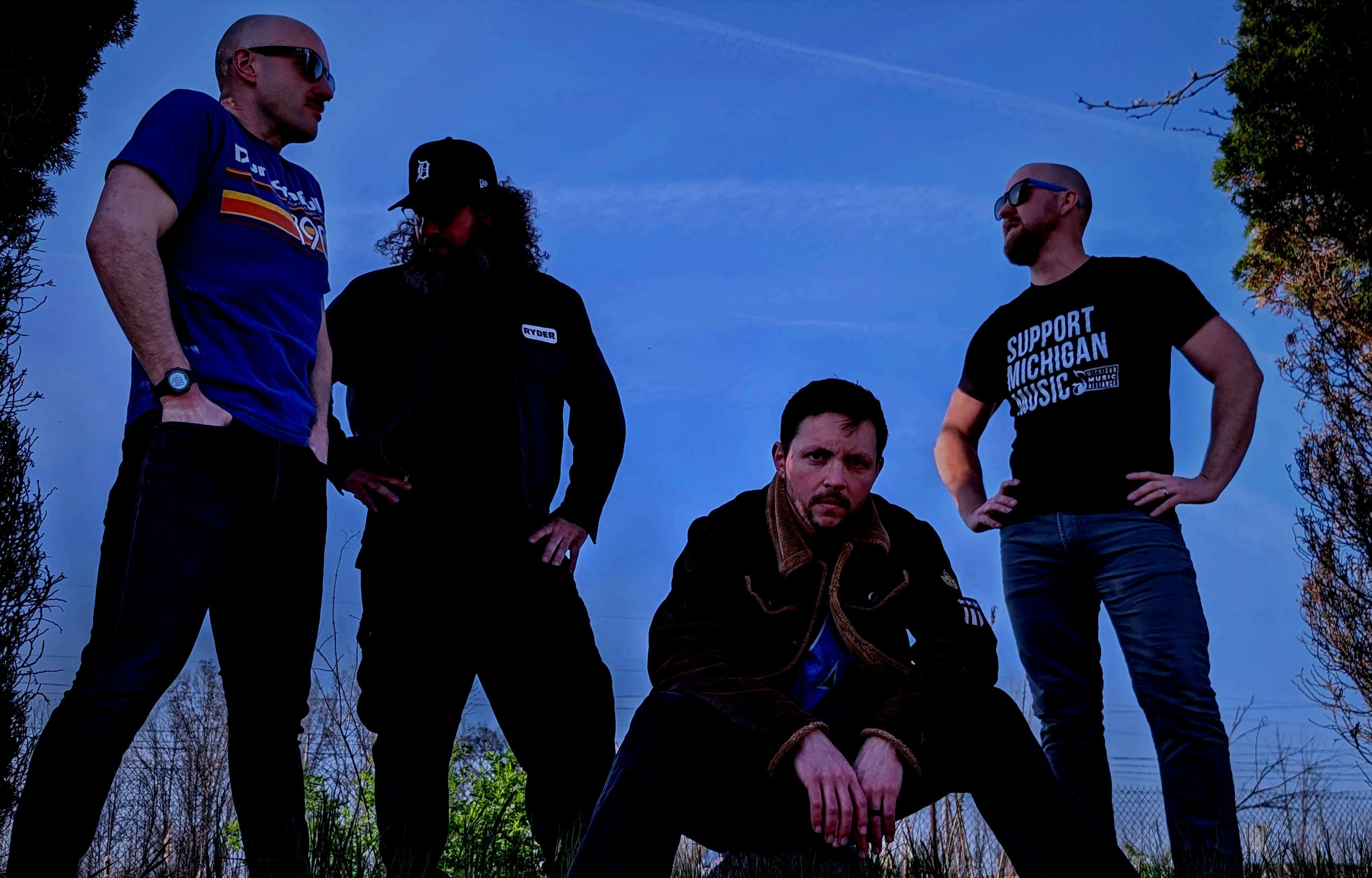 a group of men posing in front of a blue sky