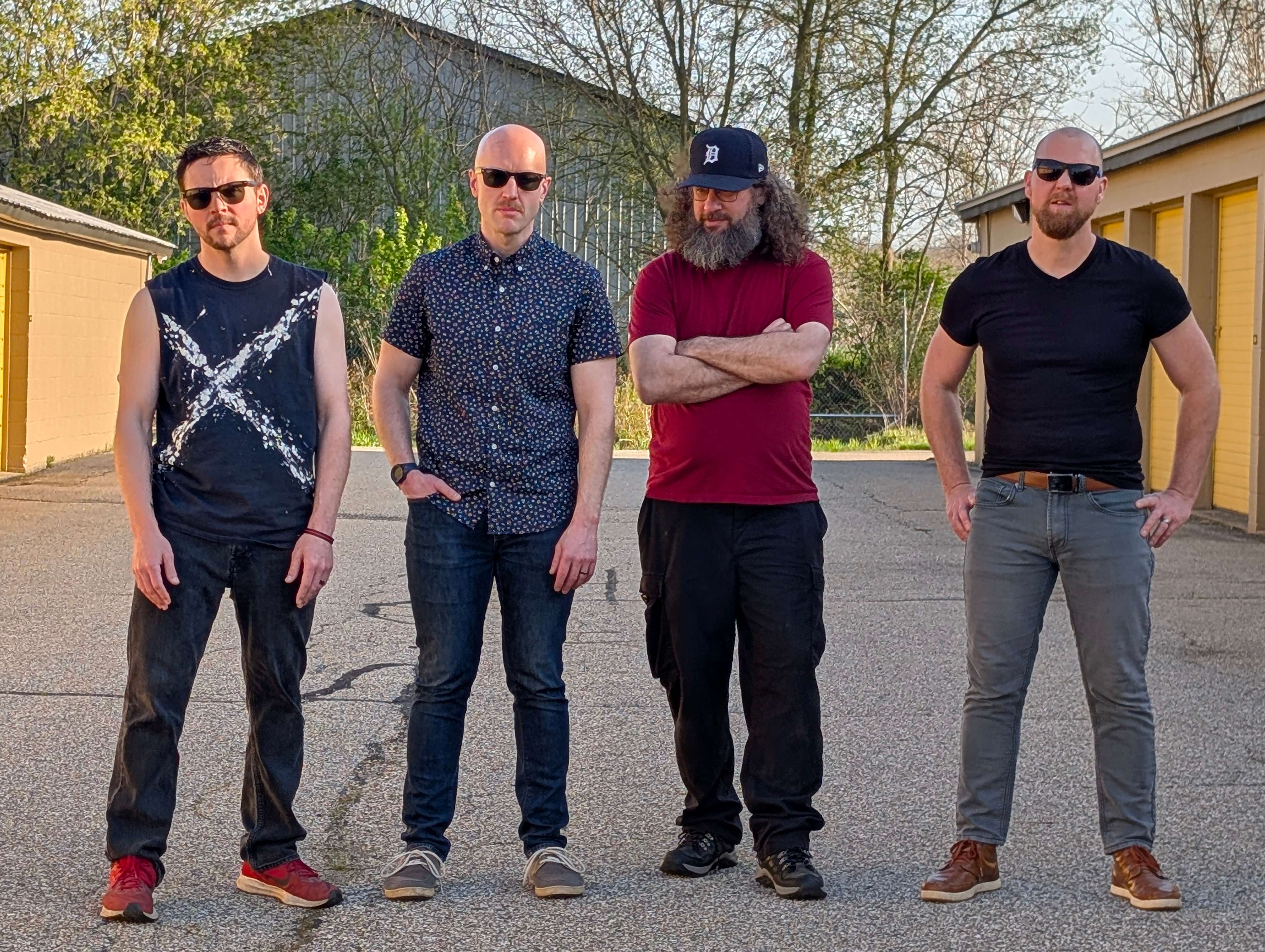 a group of men standing in front of a garage