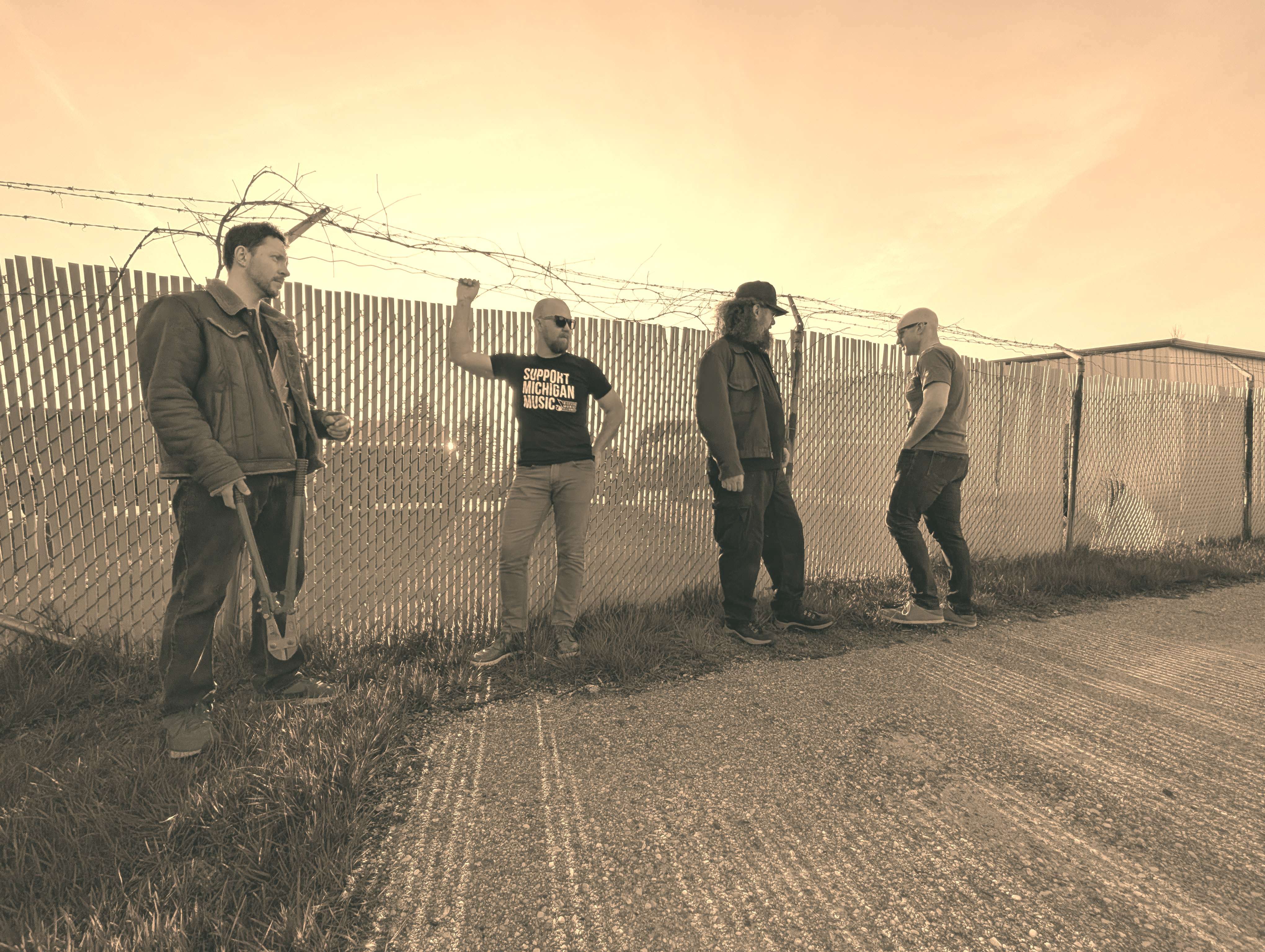 a group of people standing next to a fence