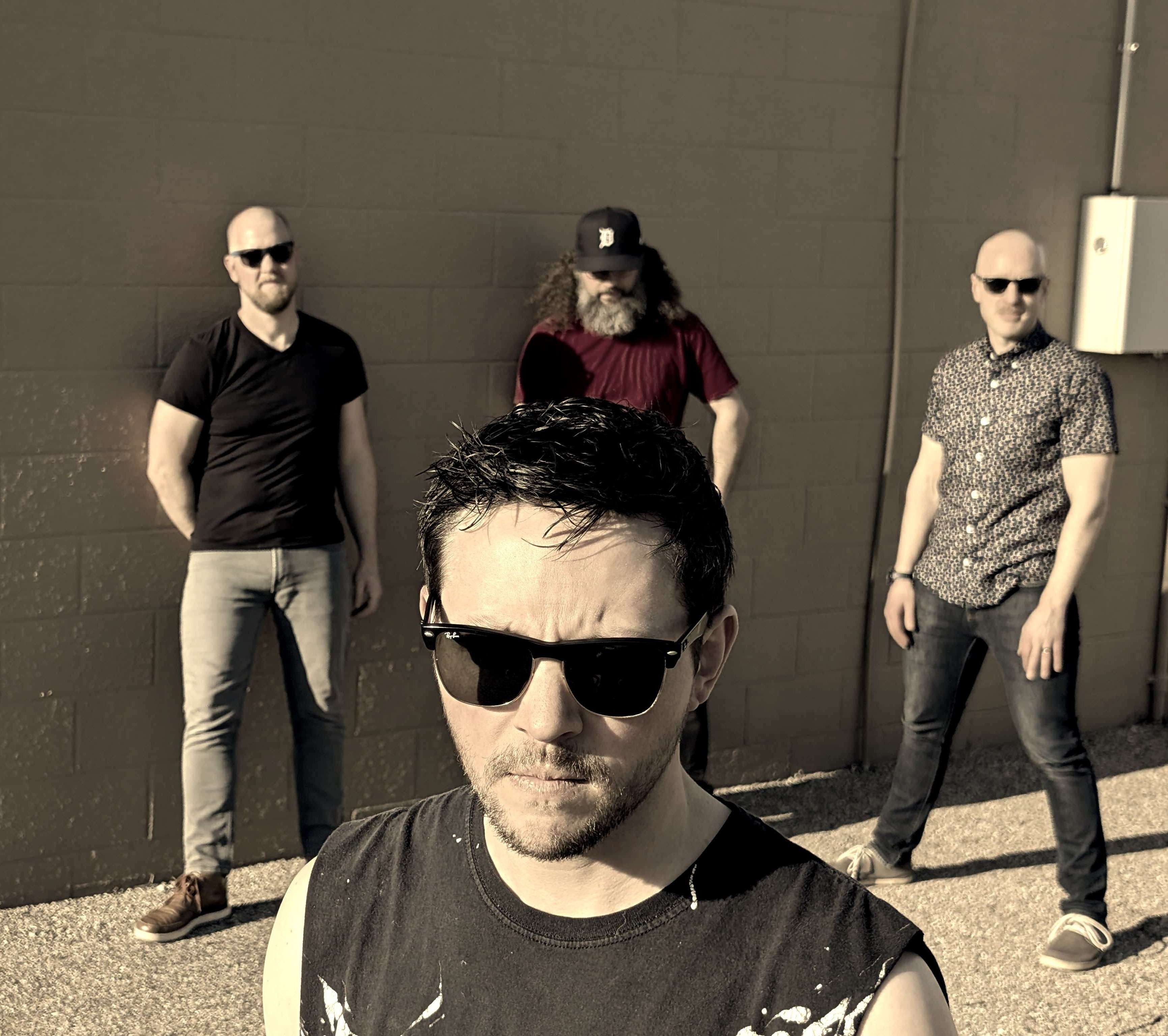 a group of men standing in front of a wall