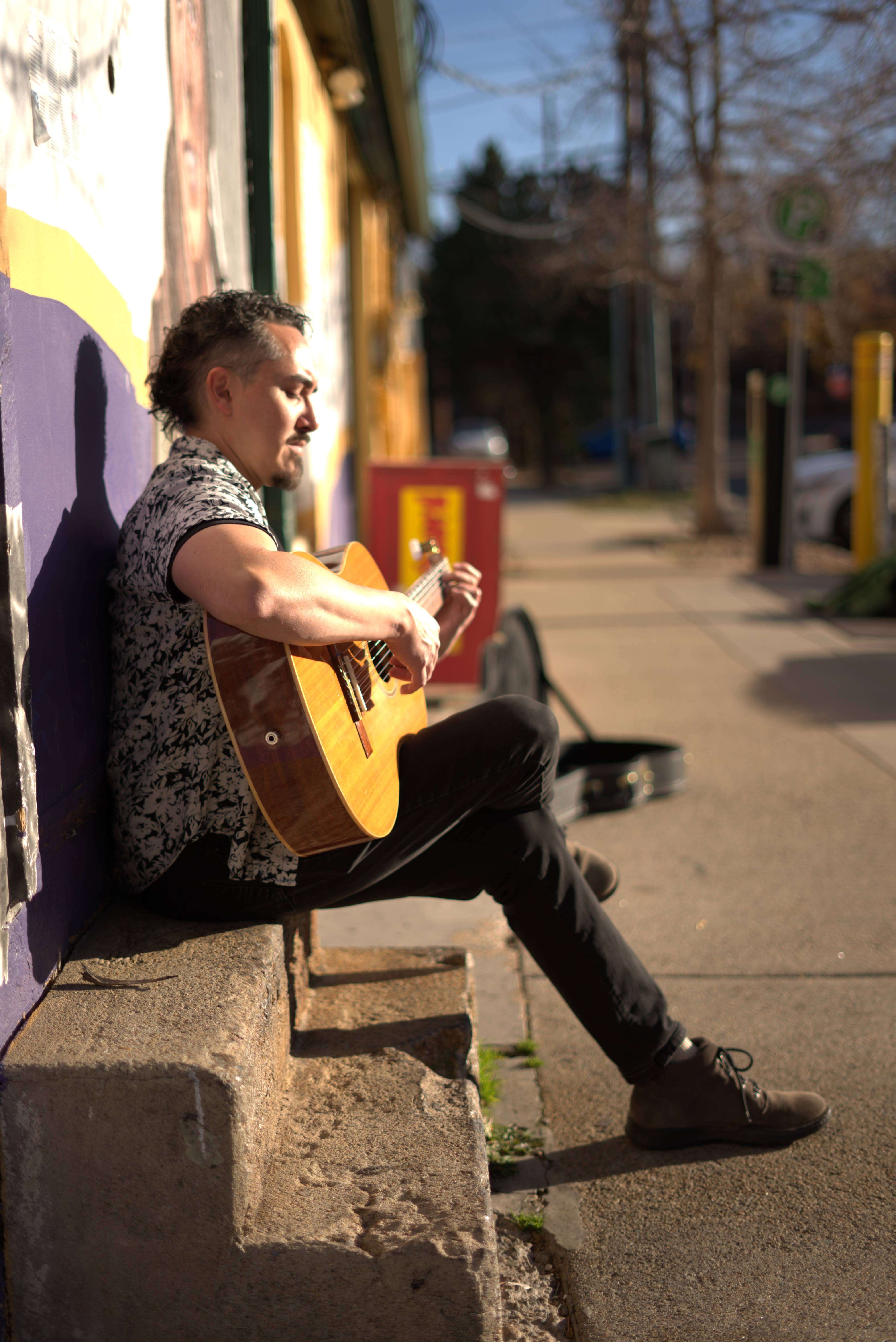 a man playing an acoustic guitar