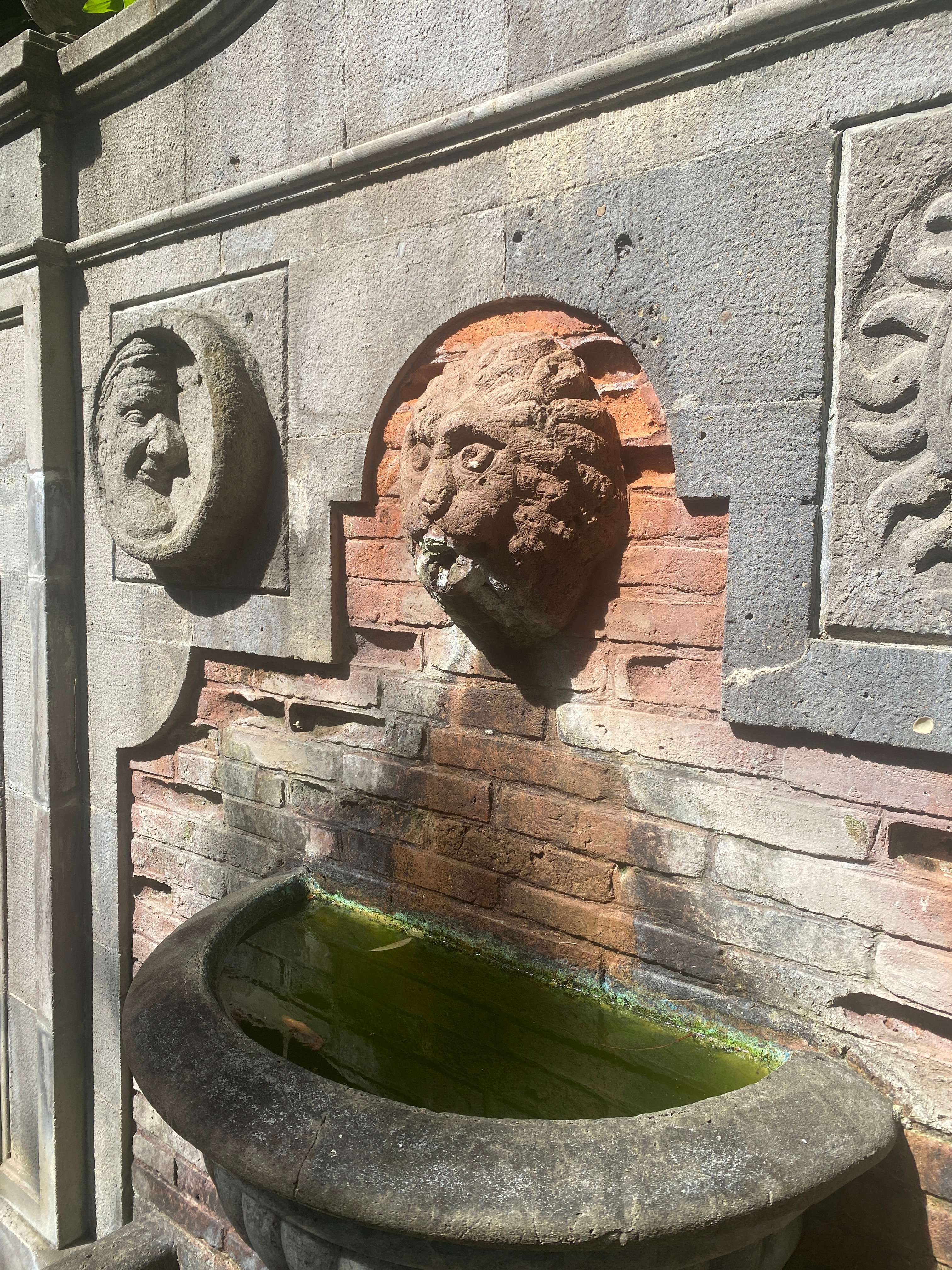 a fountain with a lion head on it