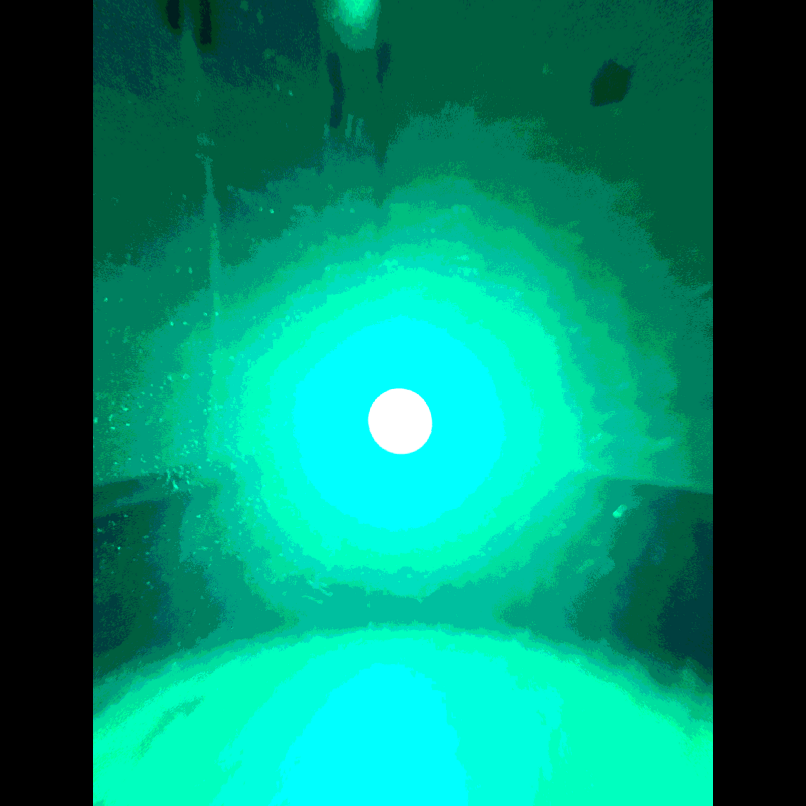 an image of a green light in a dark room