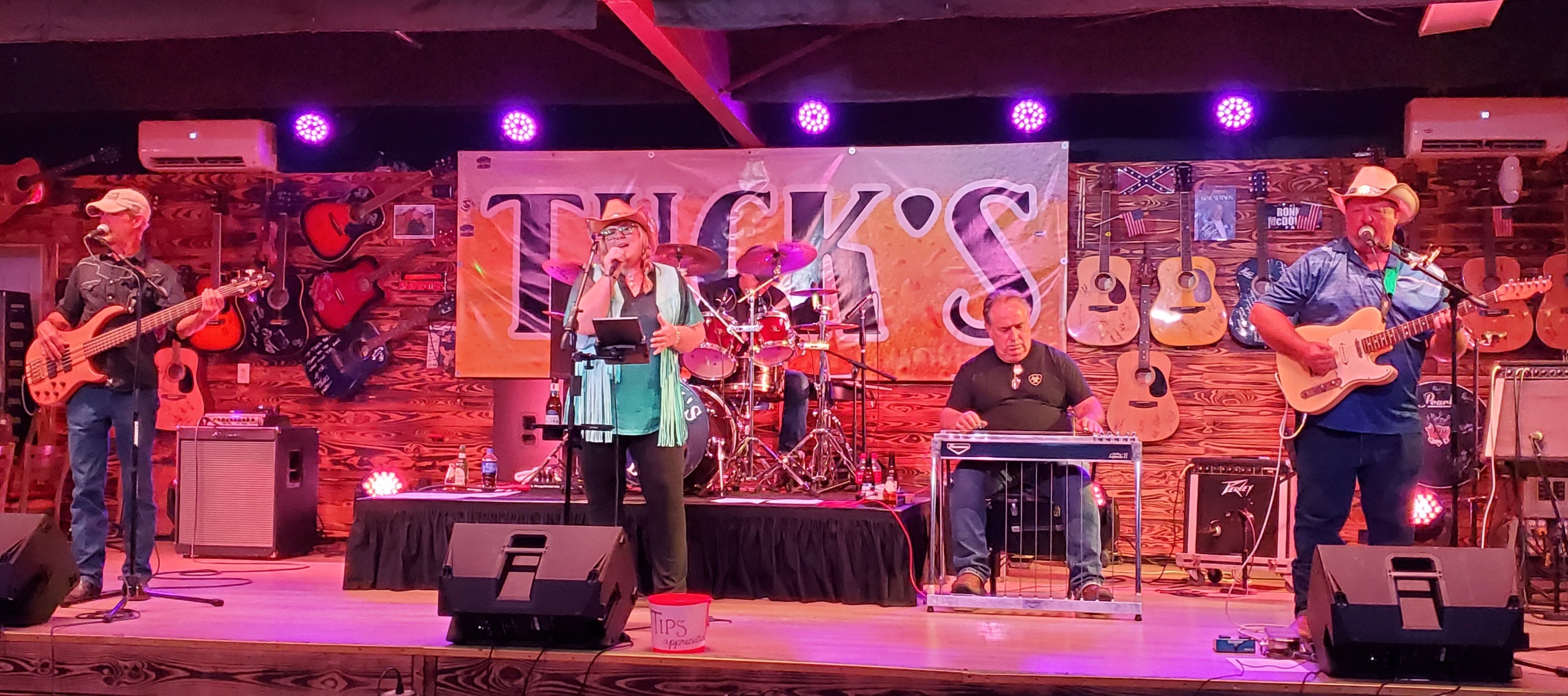 a group of people on stage at a music venue