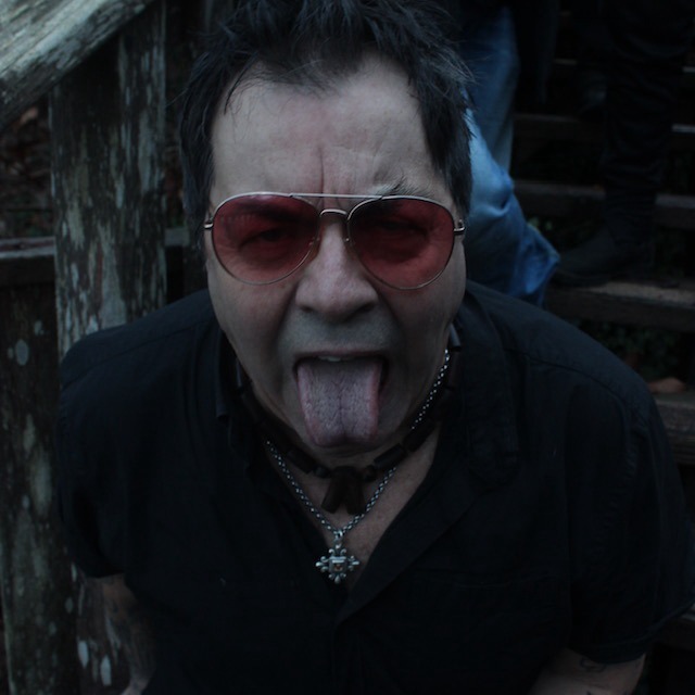 a man with sunglasses sticking his tongue out