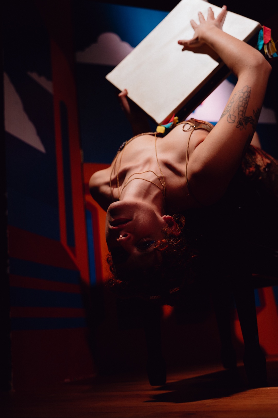a woman laying on a chair with a book on her head