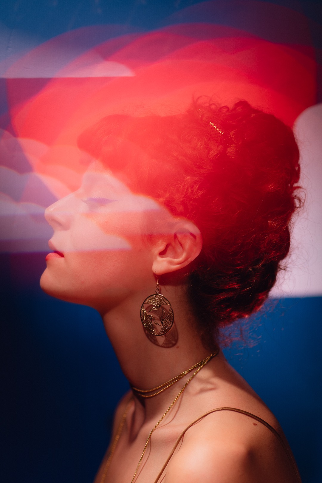 a woman with red hair in front of a blue sky