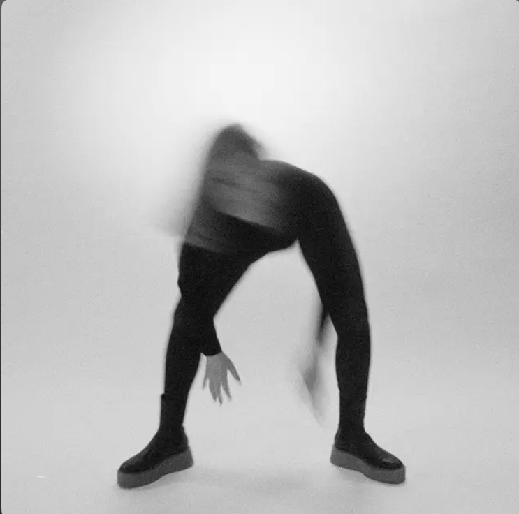 a black and white photo of a person doing a dance