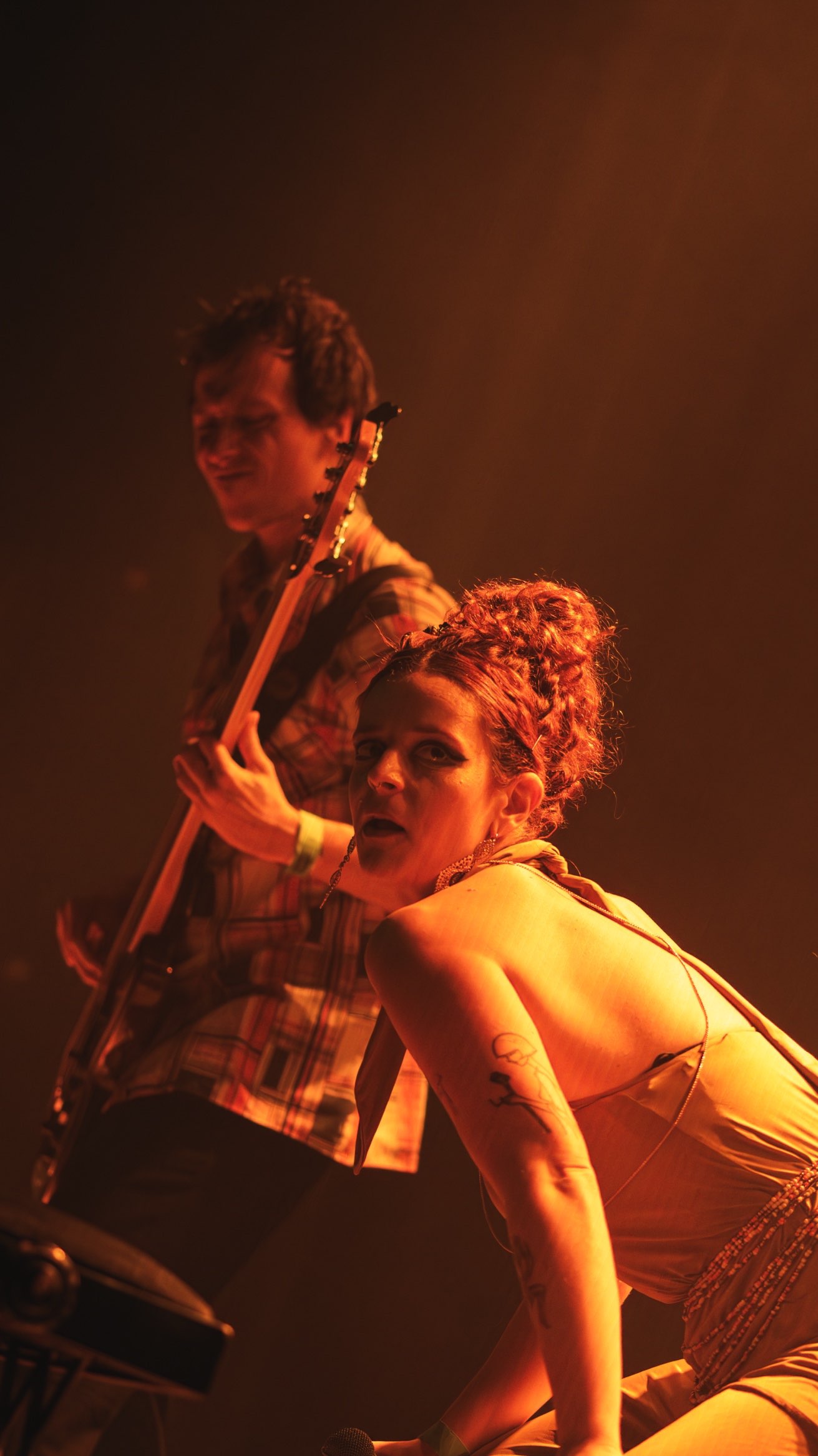 a woman on stage with a guitar