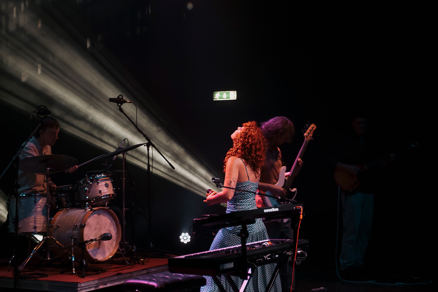a group of people standing on stage in front of a spotlight