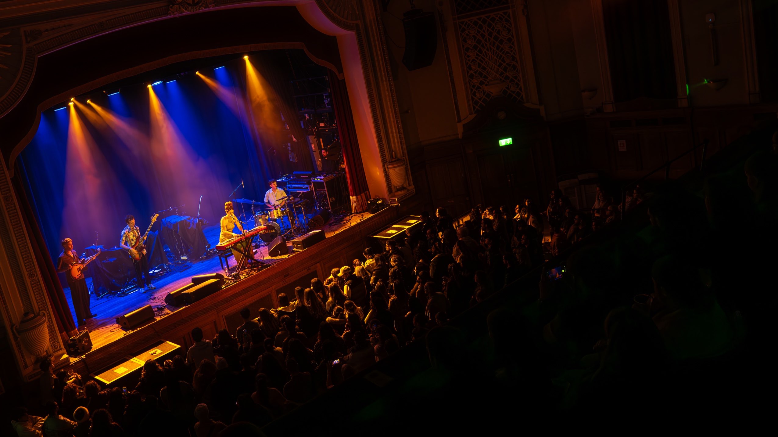 a crowd of people watching a band on stage