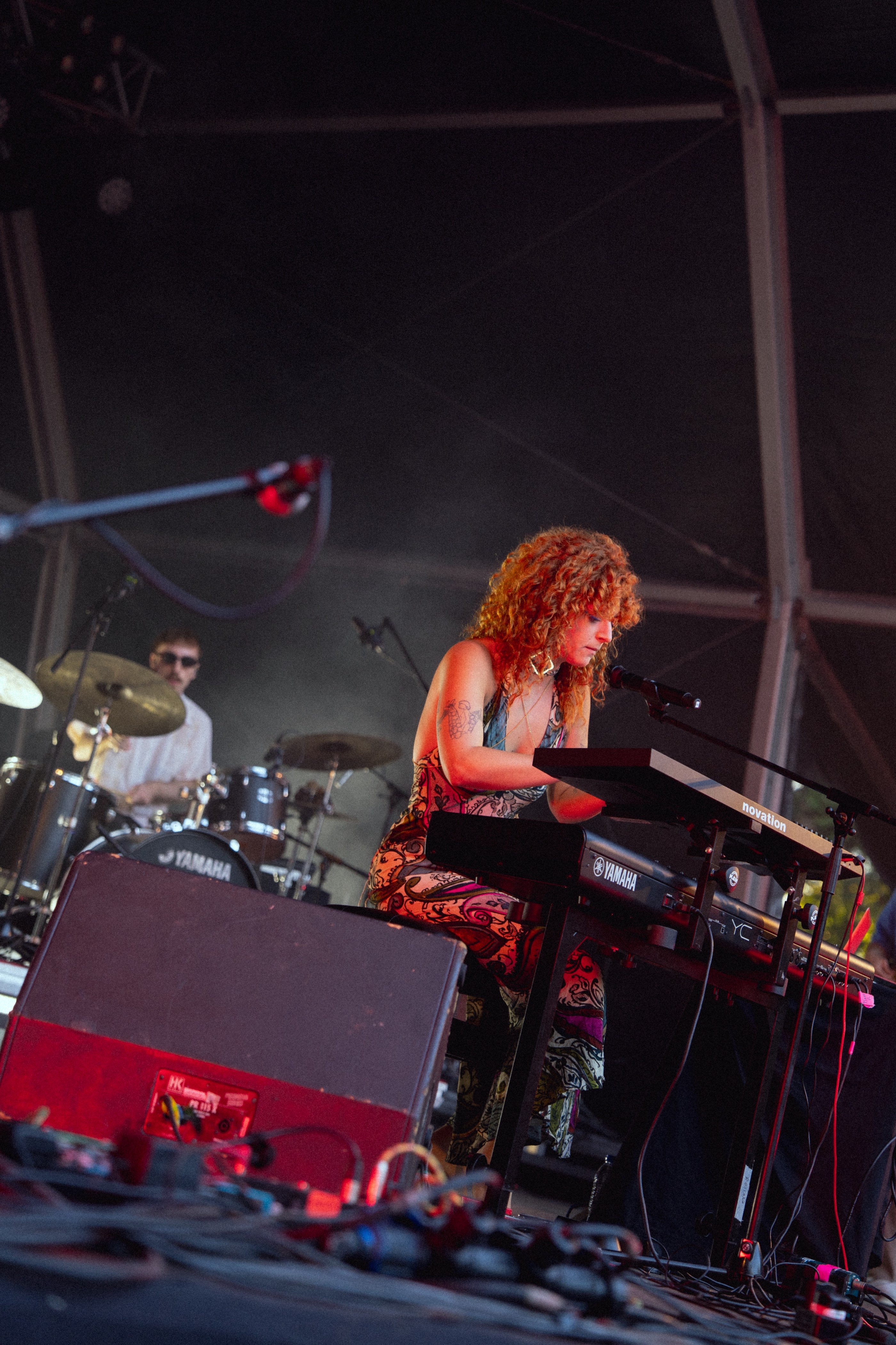 a woman playing a keyboard on stage