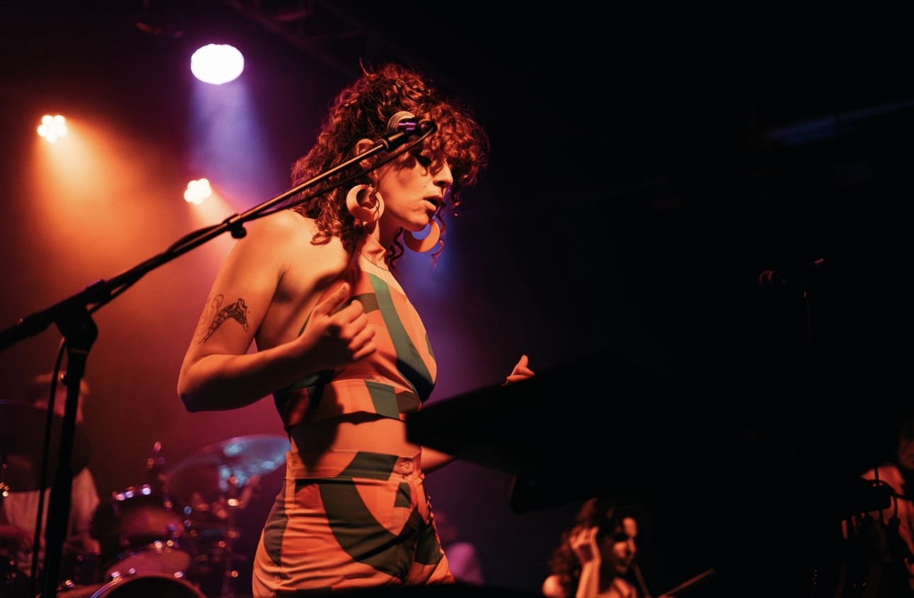 a woman in a bikini on stage with microphones