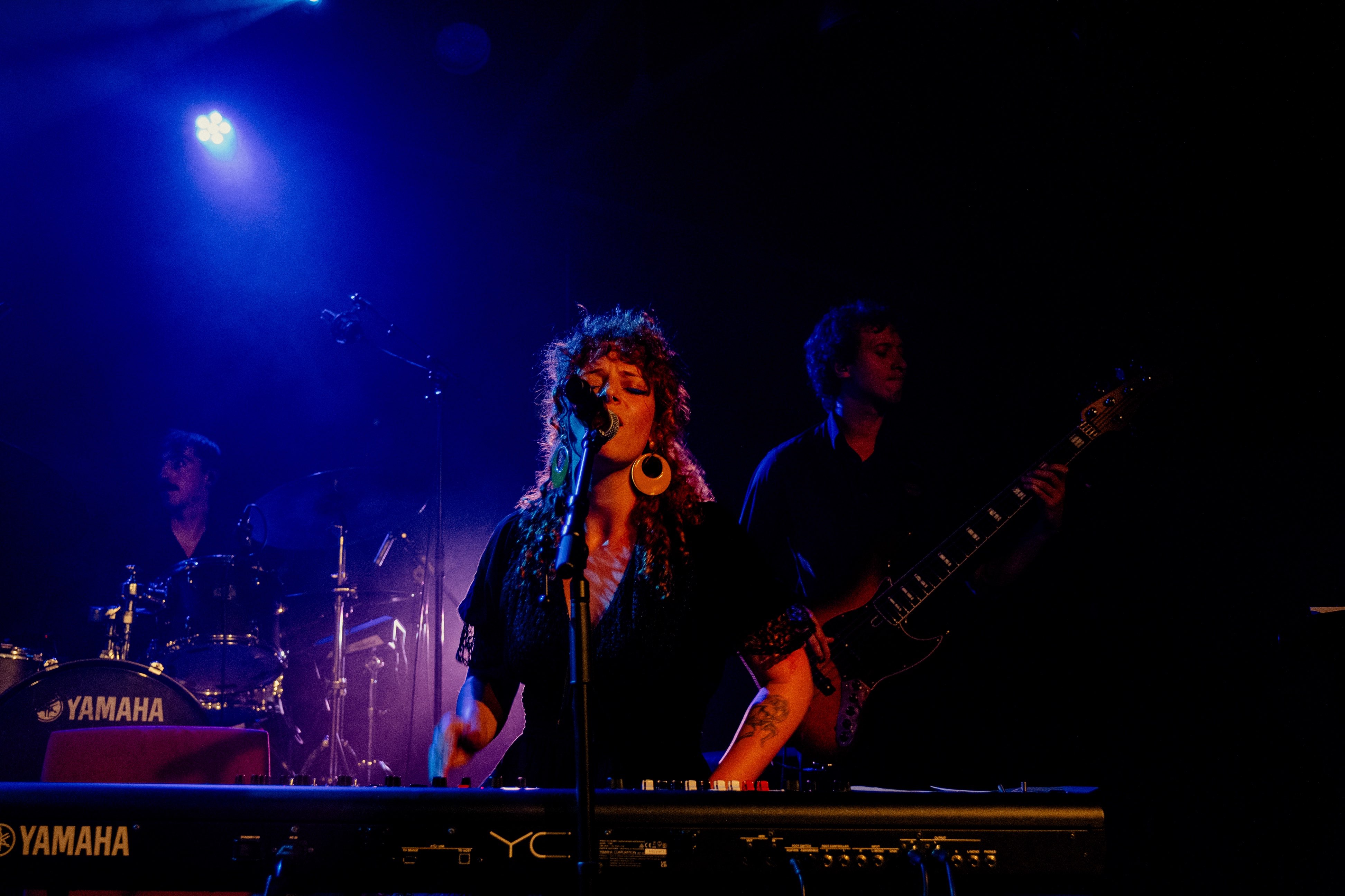 a woman is playing a keyboard on stage