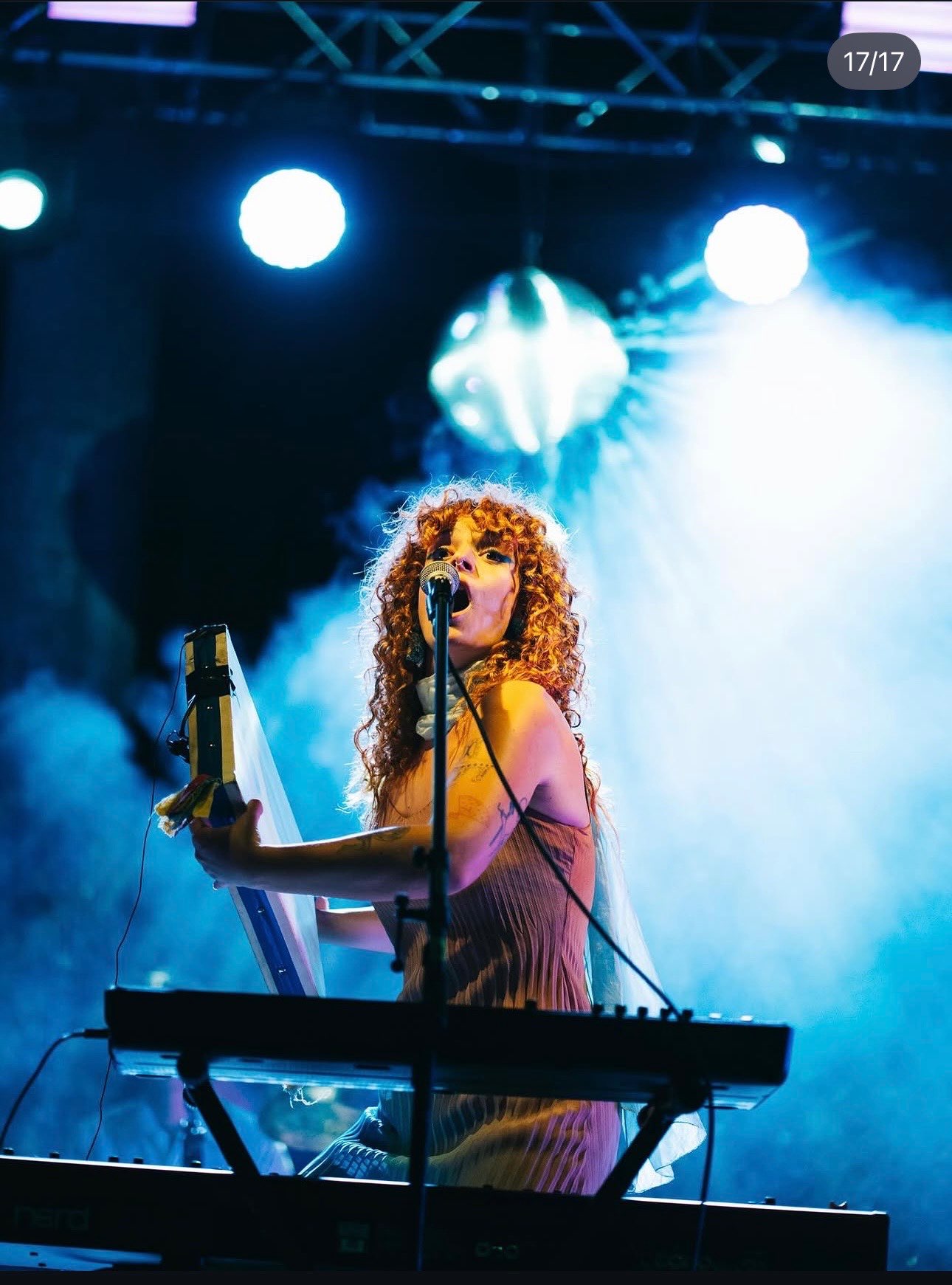 a woman playing a keyboard at a concert