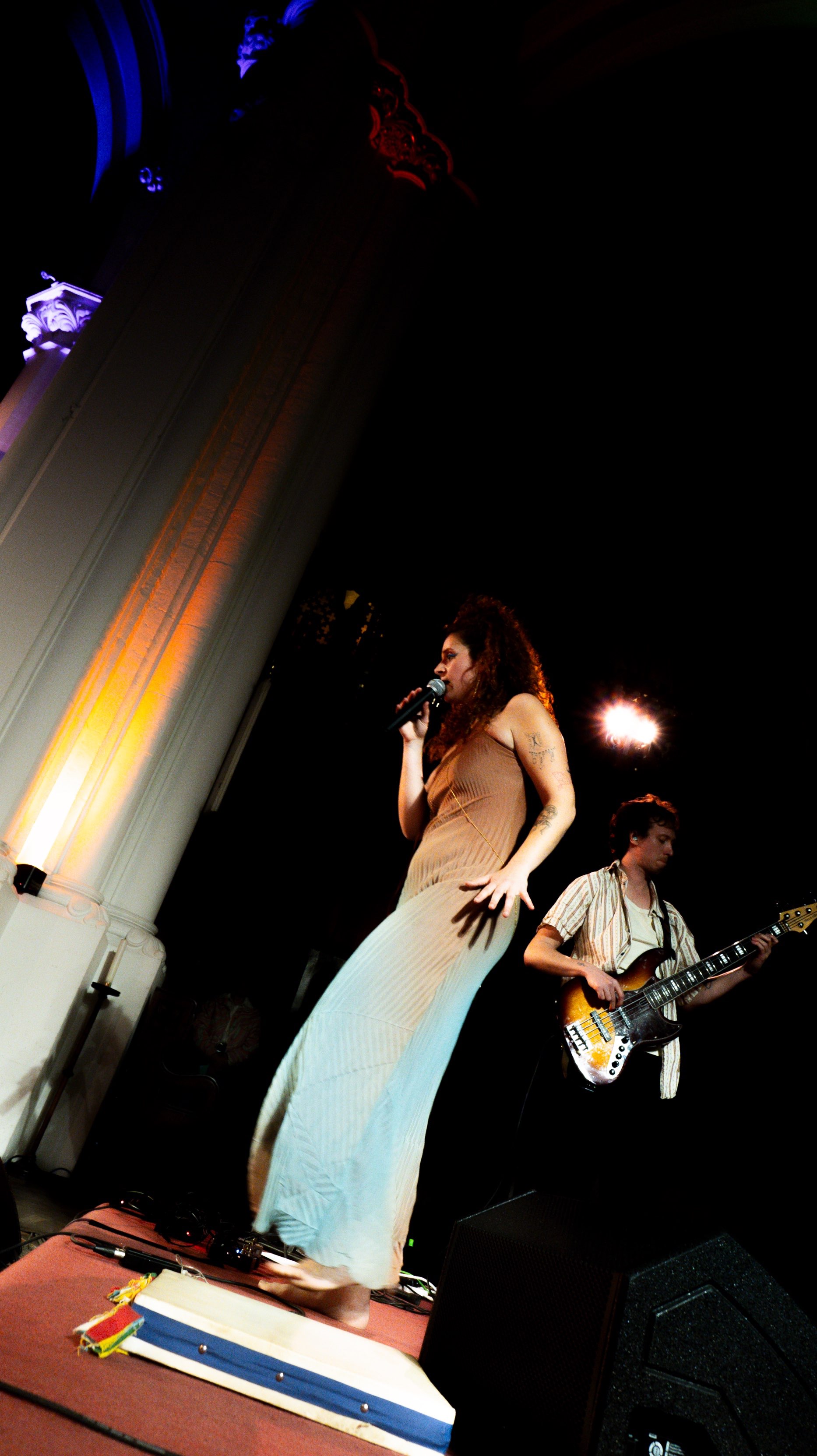 a woman on stage with a guitar
