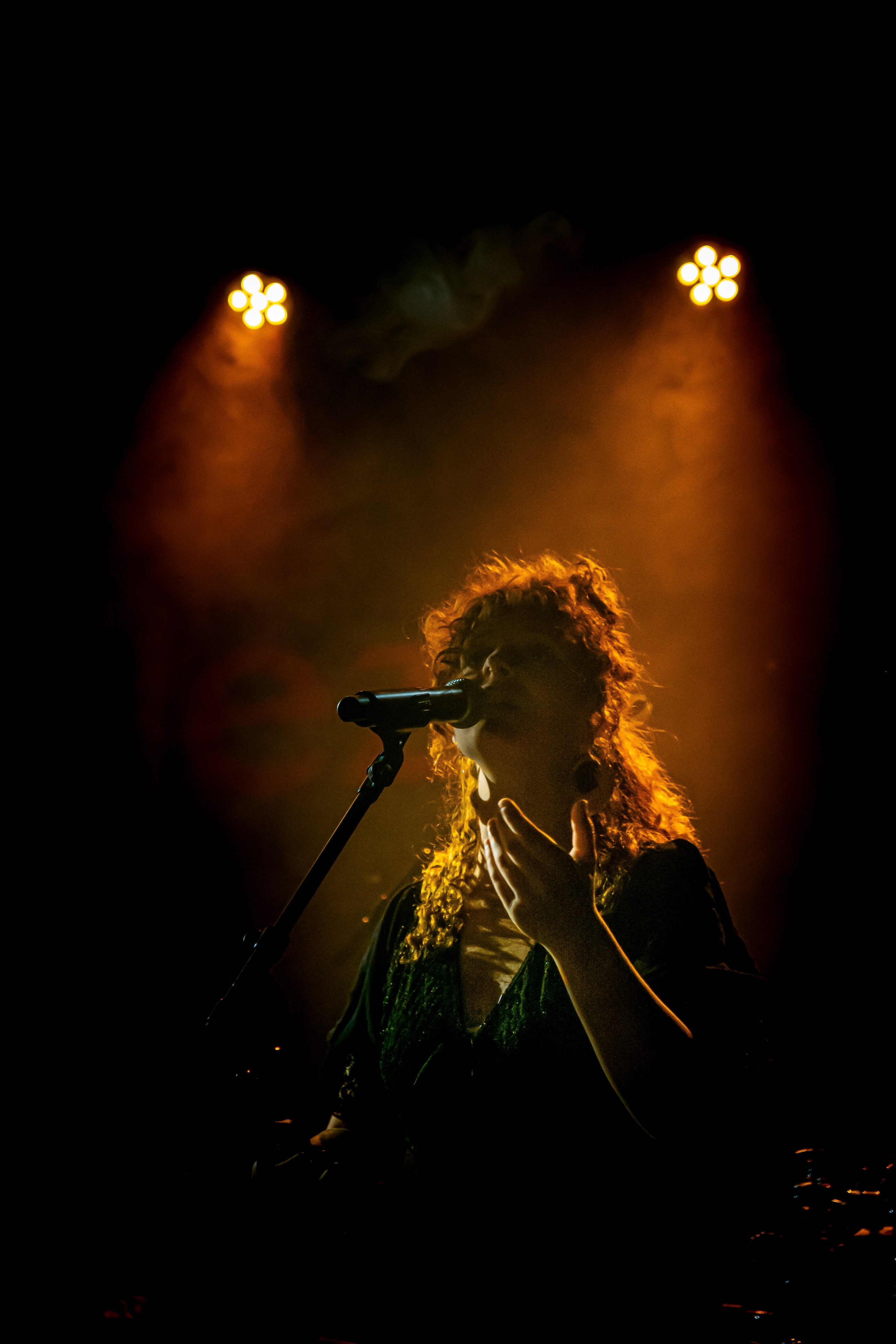 a woman singing into a microphone