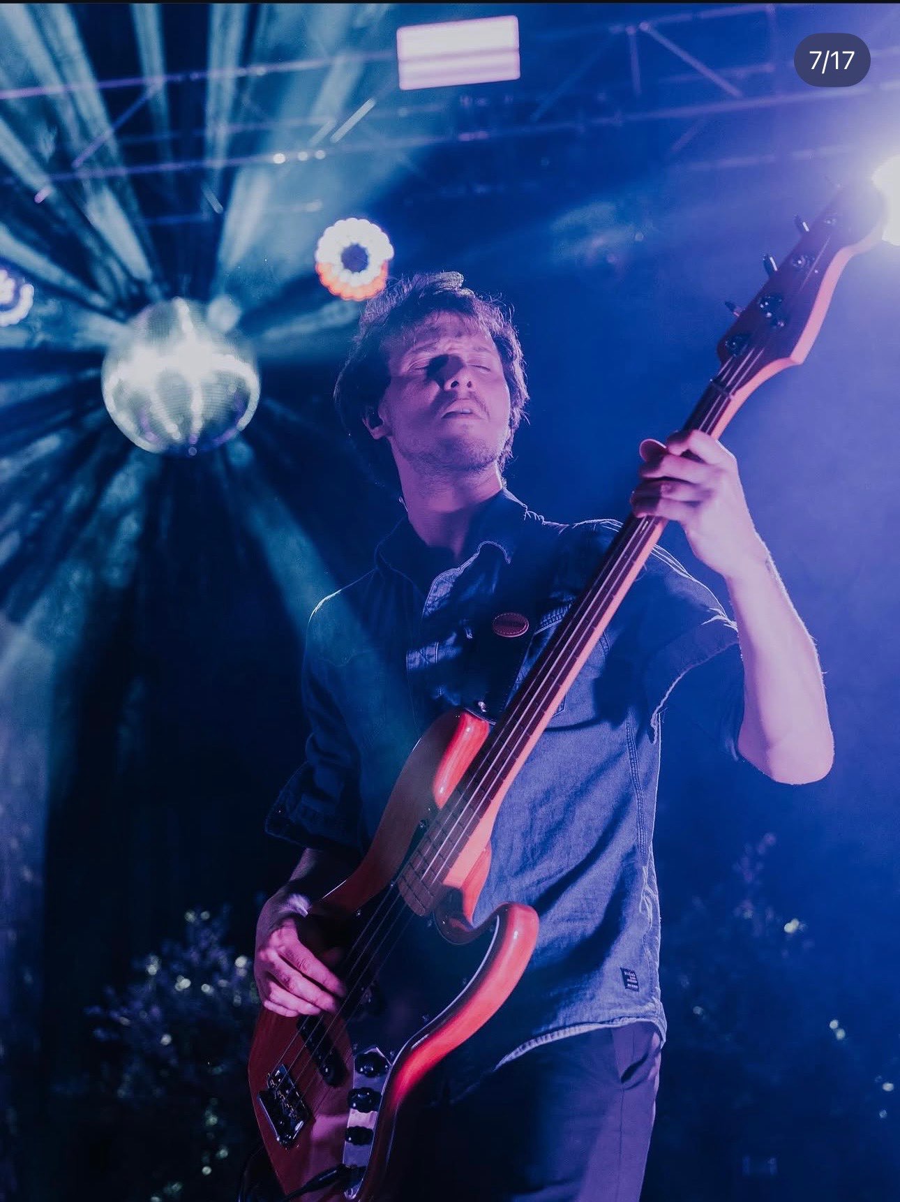 a man playing a bass at a concert