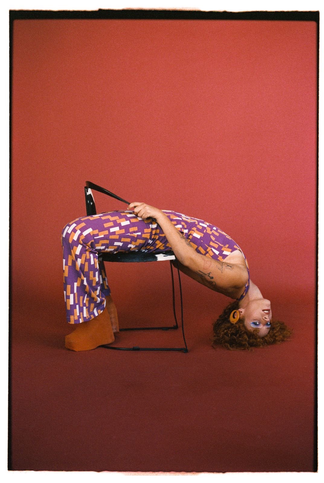 a woman is laying on a chair