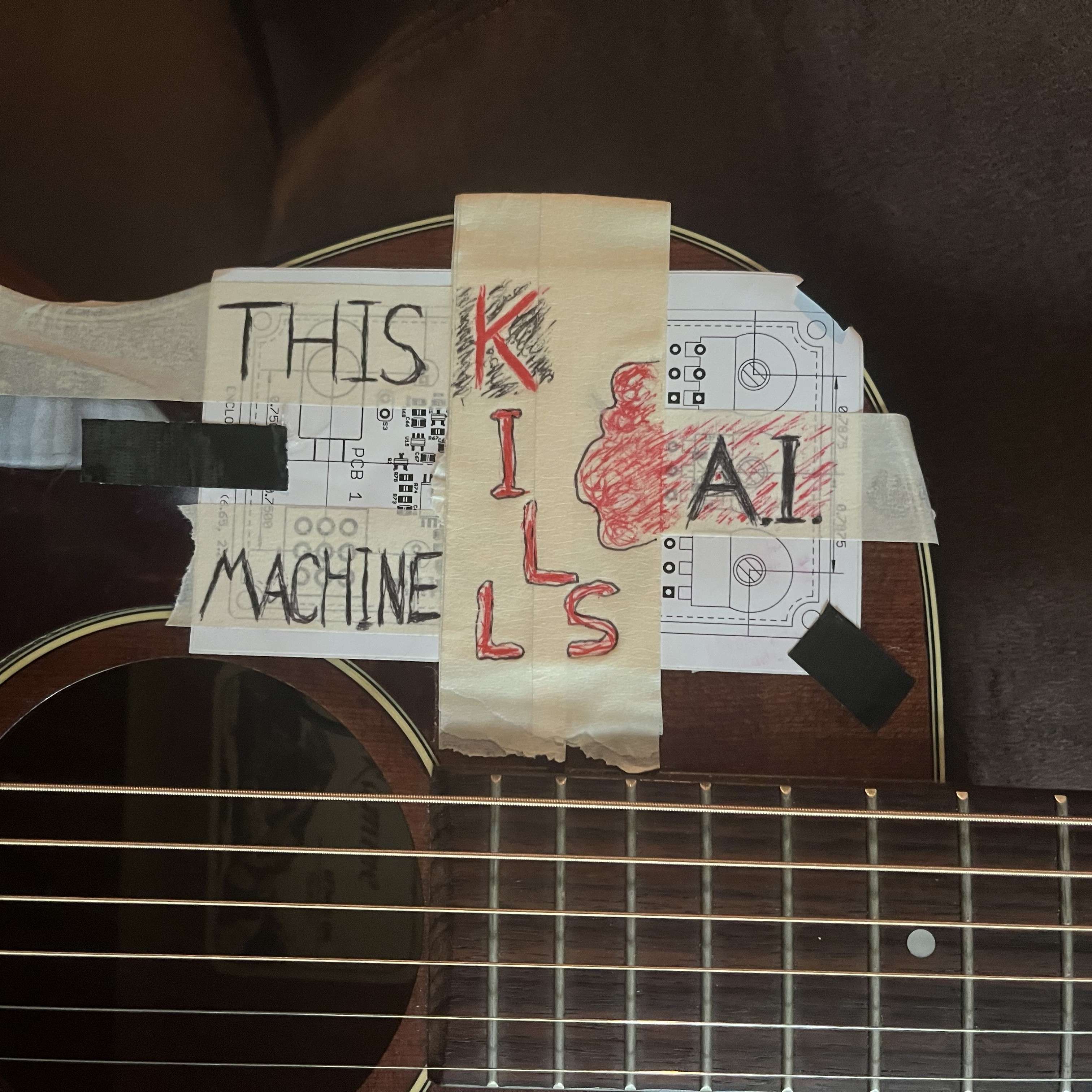 an acoustic guitar with tape on it that says this kills machine
