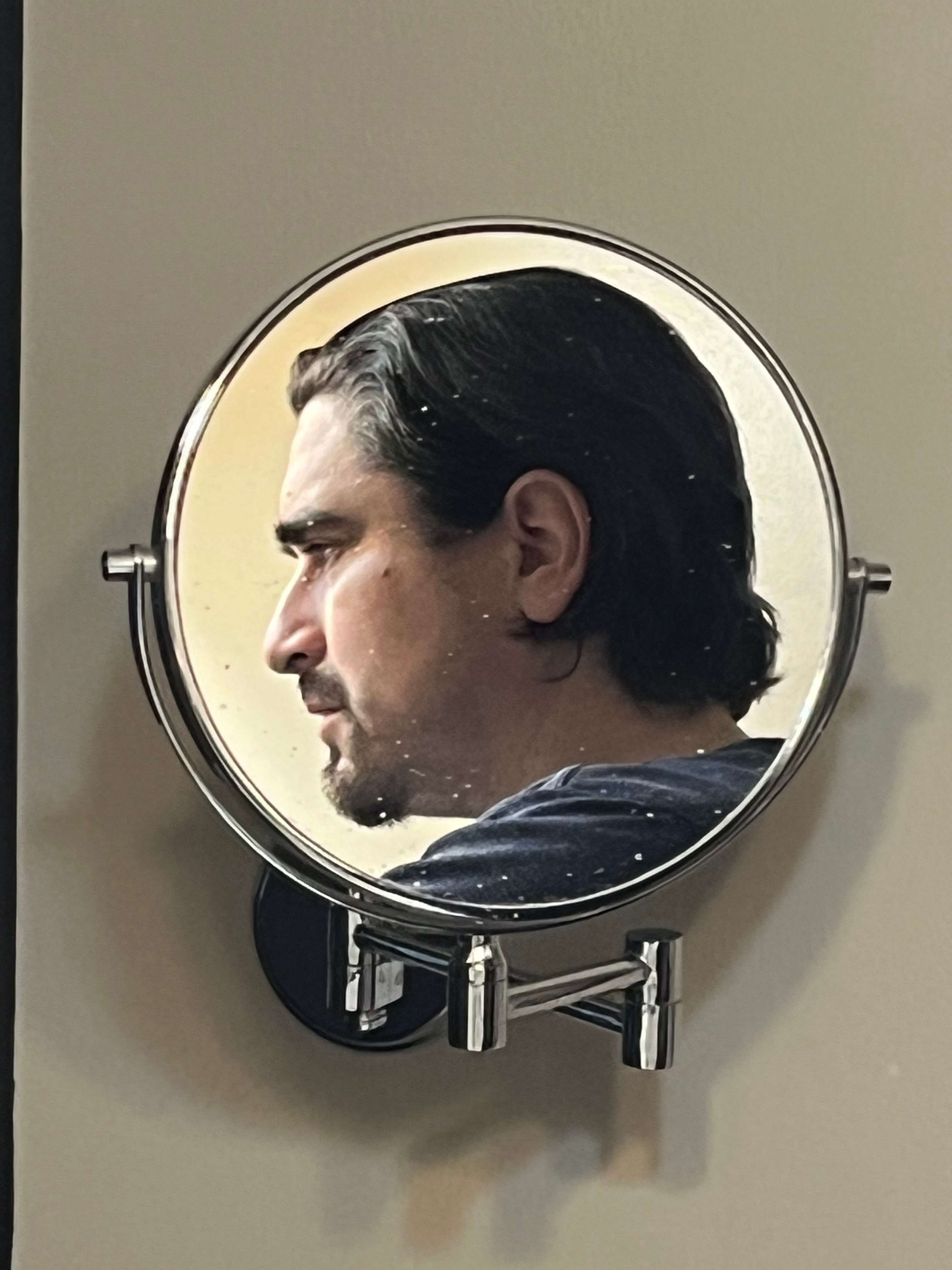 a mirror with a man's face in it