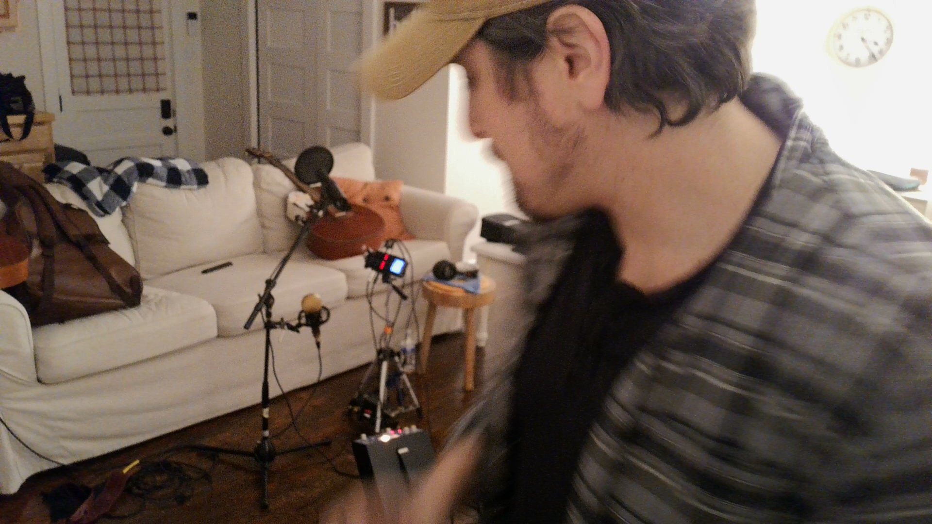 a man playing a guitar in a living room