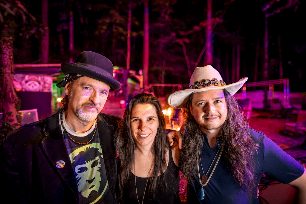 three people in cowboy hats posing for a photo