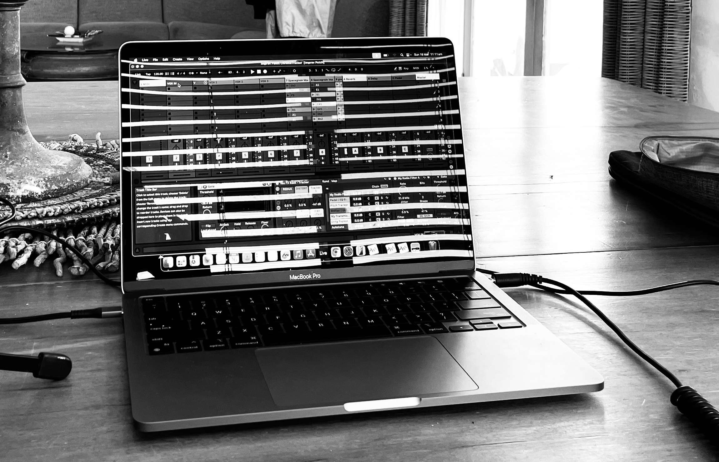 a black and white photo of a laptop on a table