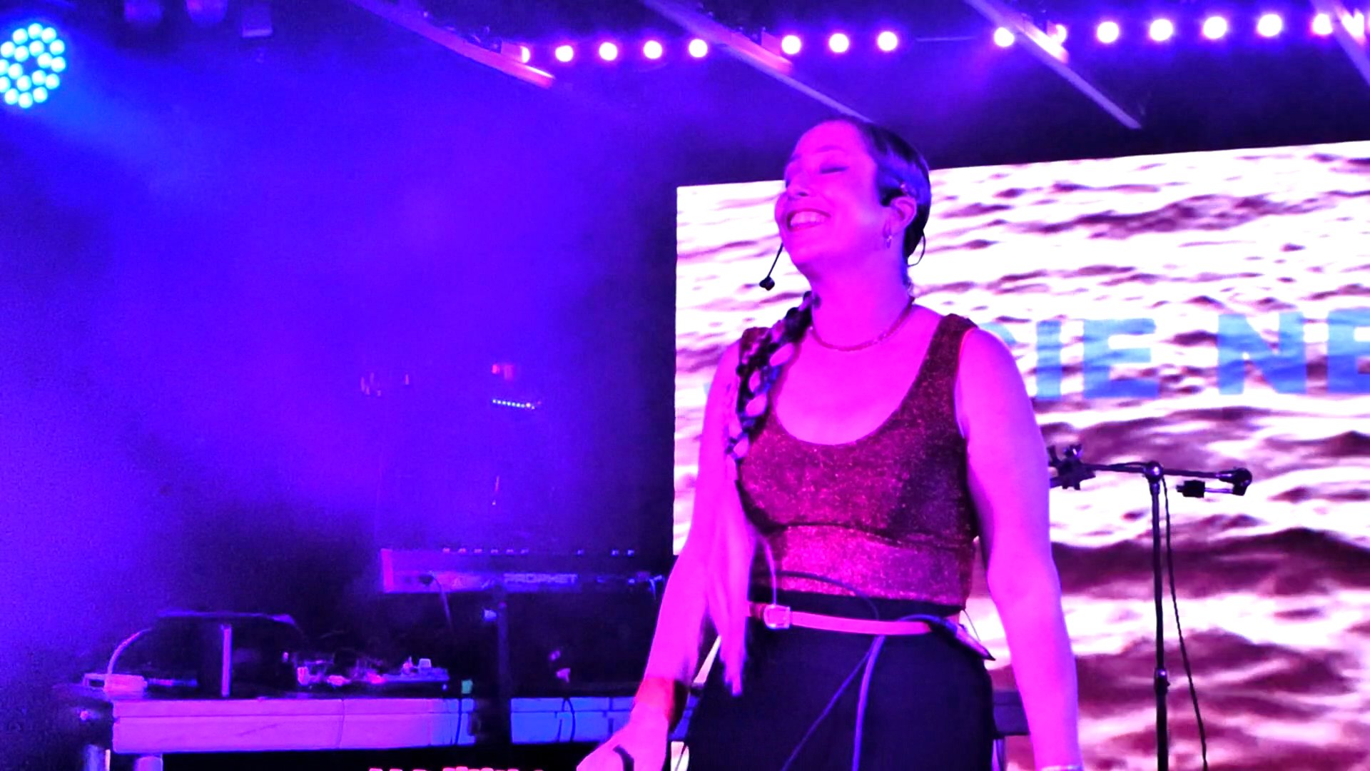 a woman singing on stage at a concert