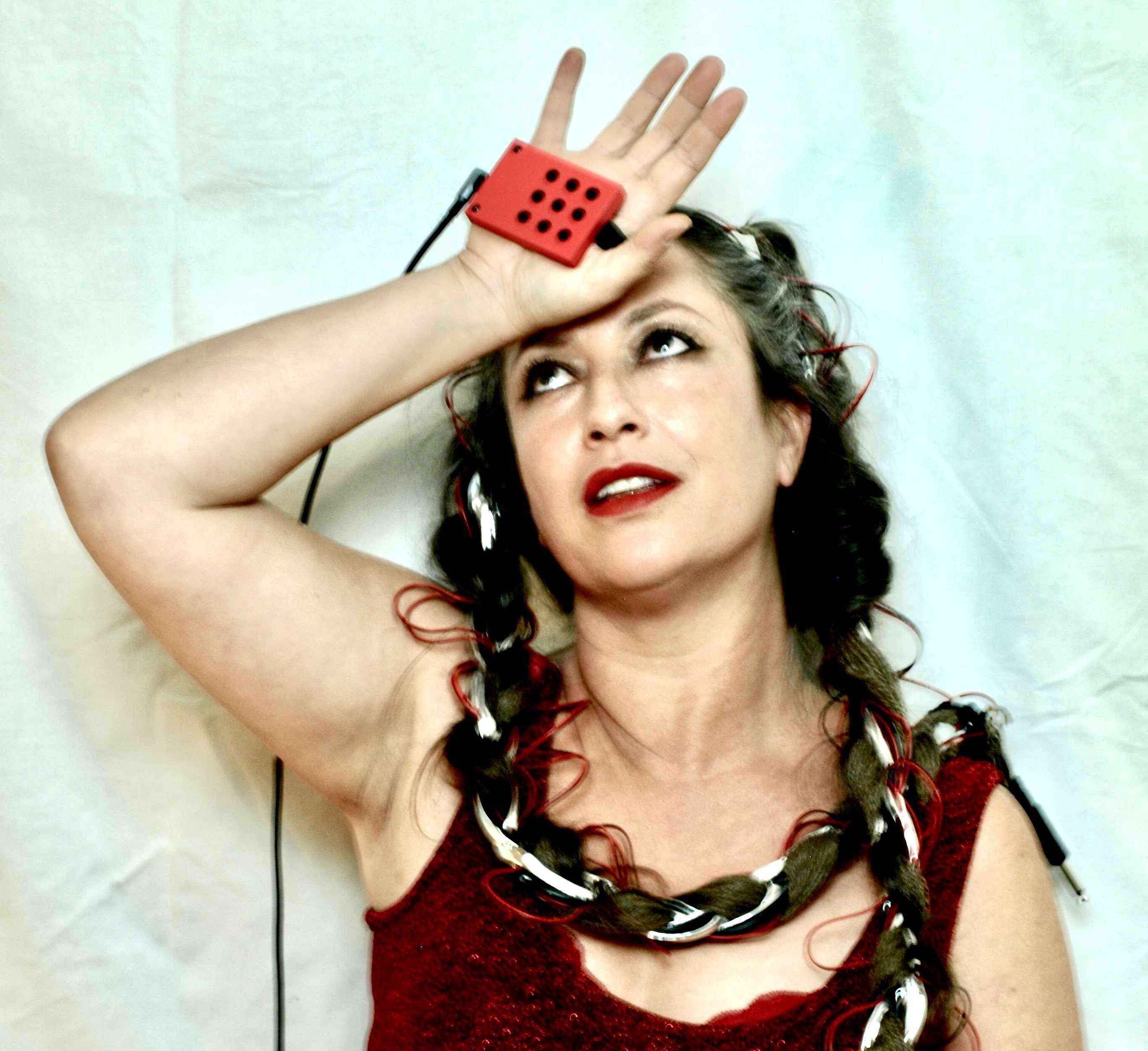a woman in a red dress holding a remote control