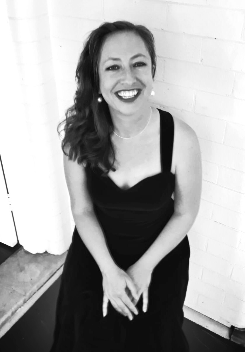 a black and white photo of a woman in a dress