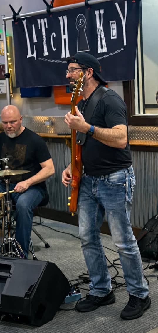 a group of men playing music in a bar