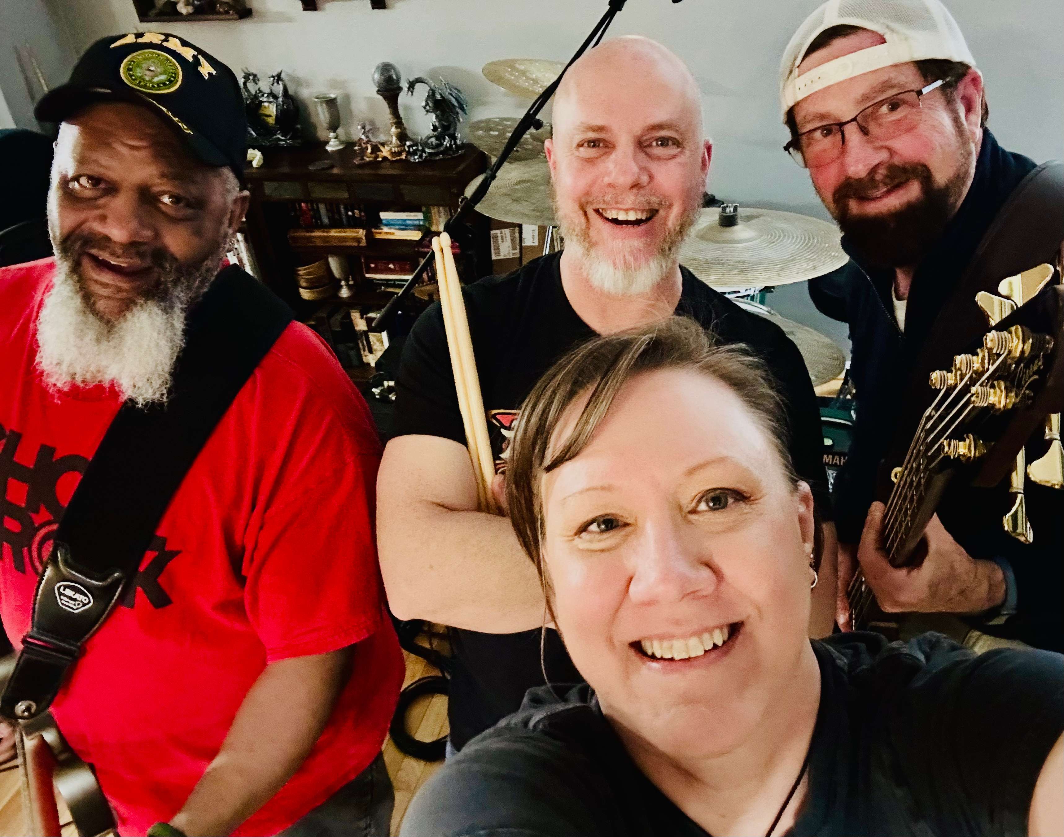 a group of people posing for a photo in a recording studio