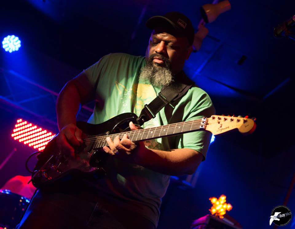 image may contain person, on stage, playing a musical instrument and night