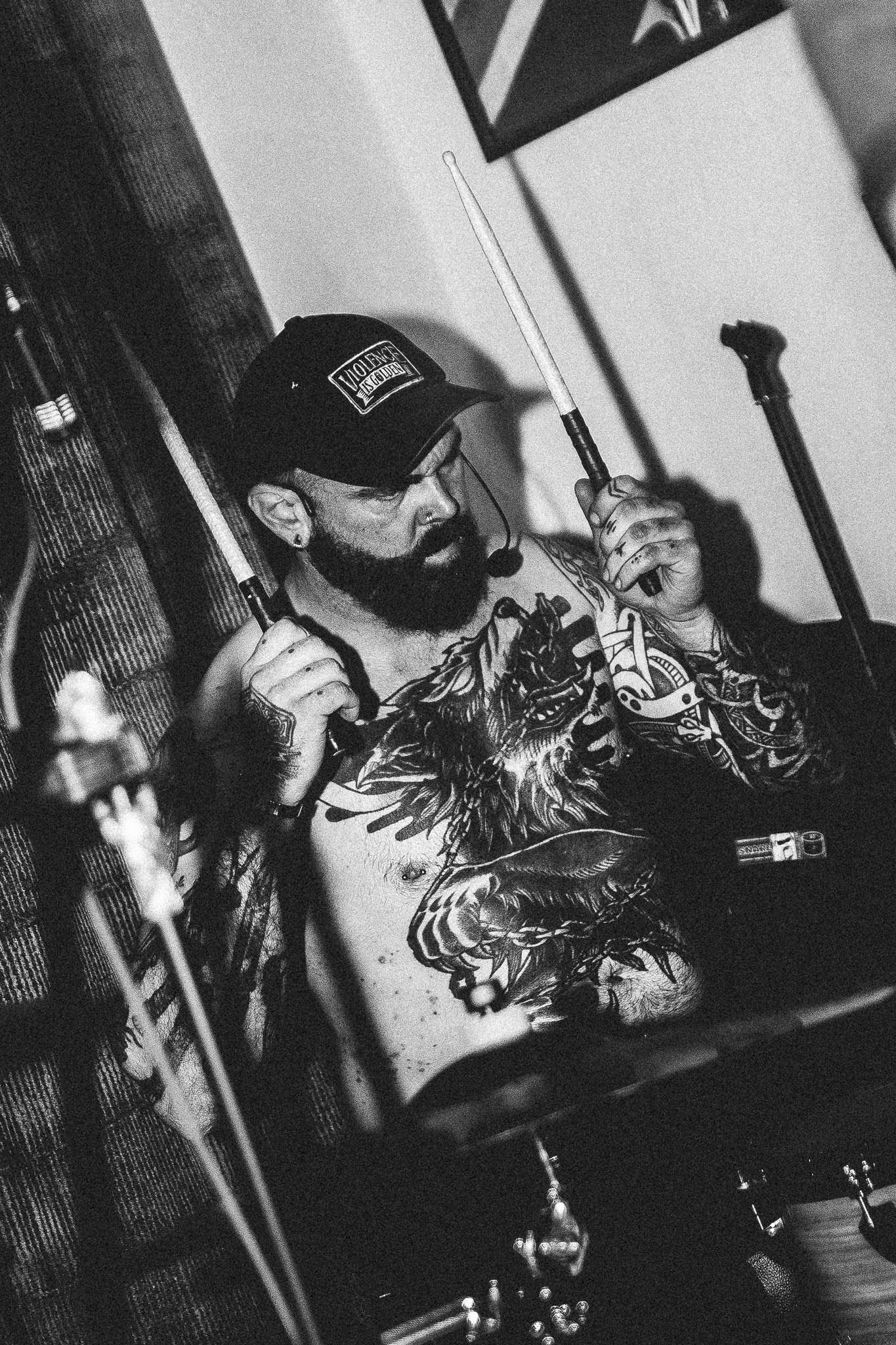 a black and white photo of a man playing drums