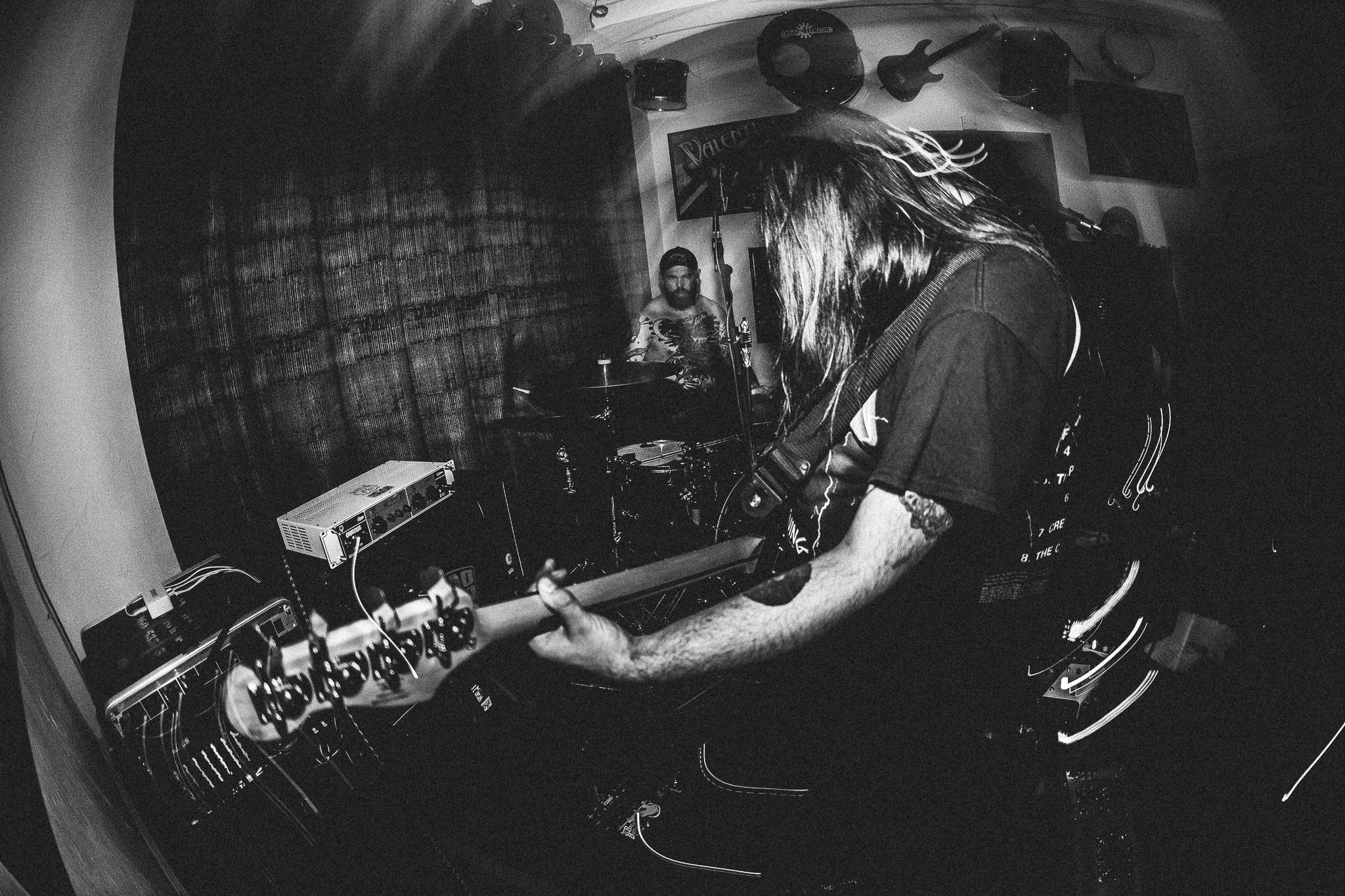 a black and white photo of a man playing a guitar