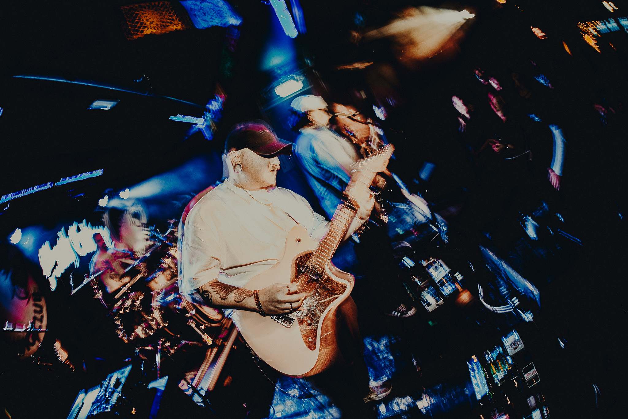 a blurry image of a man playing a guitar