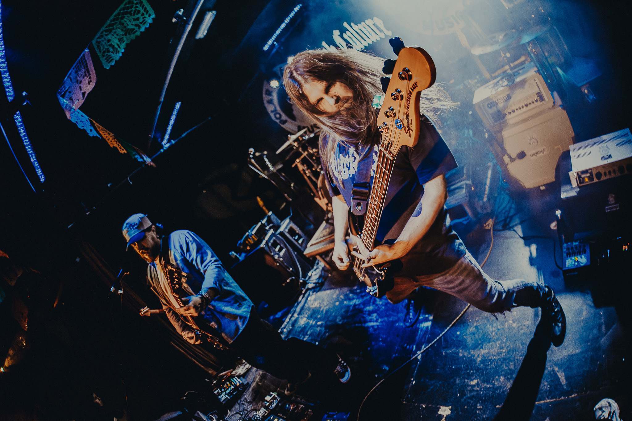 a man playing a bass on stage in front of a crowd