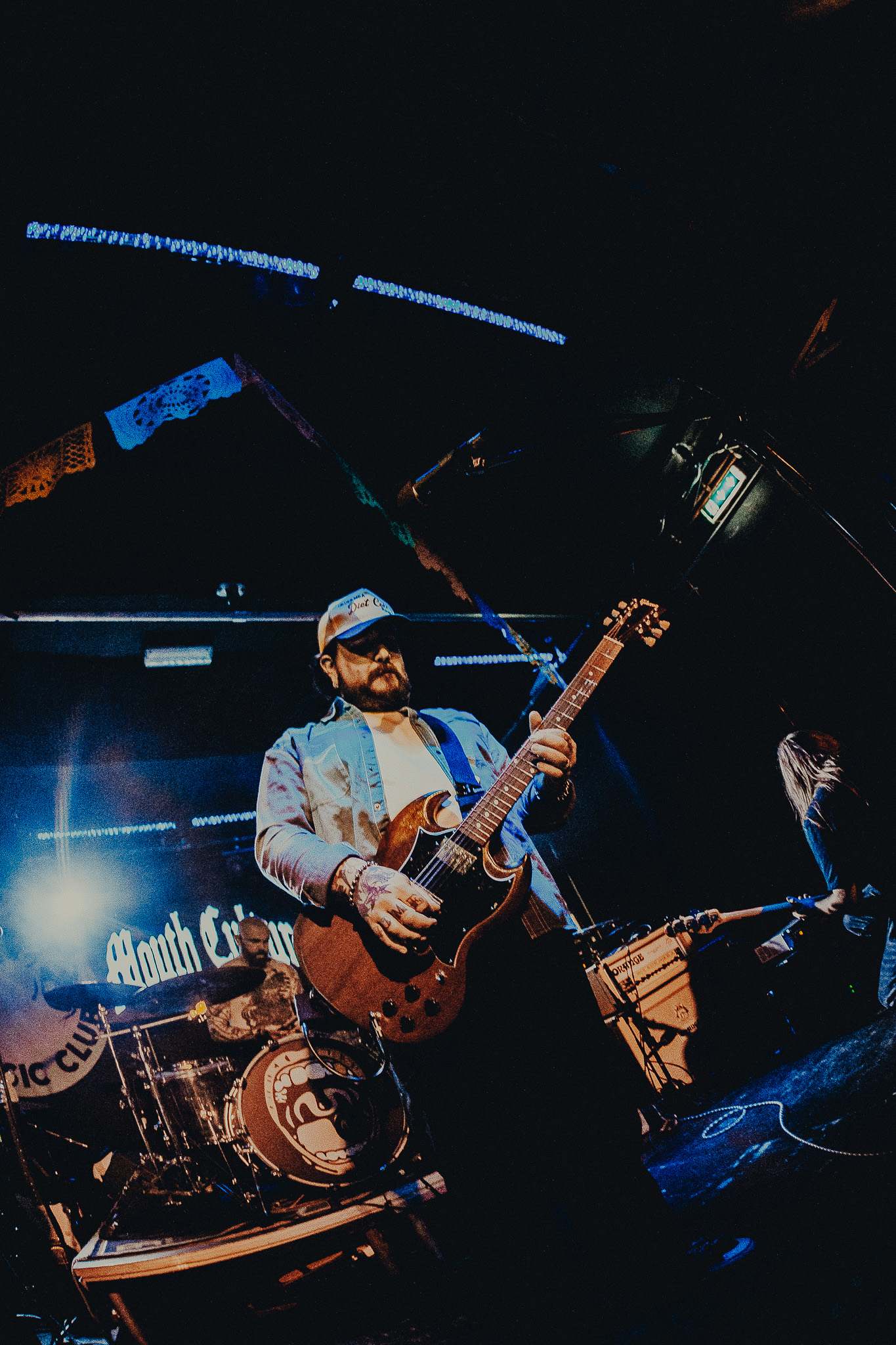 a man playing a guitar in a dark room