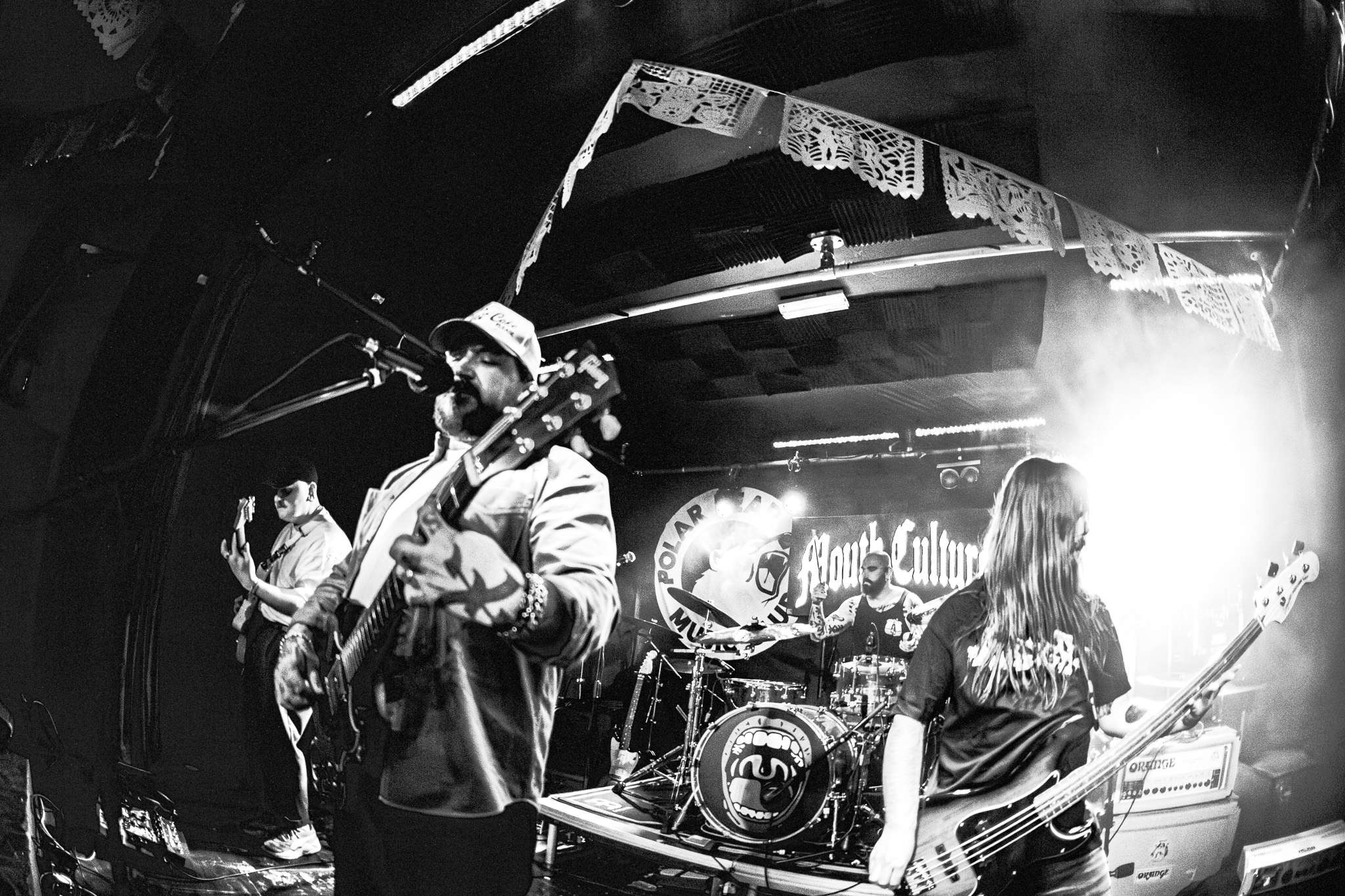 a black and white photo of a band on stage