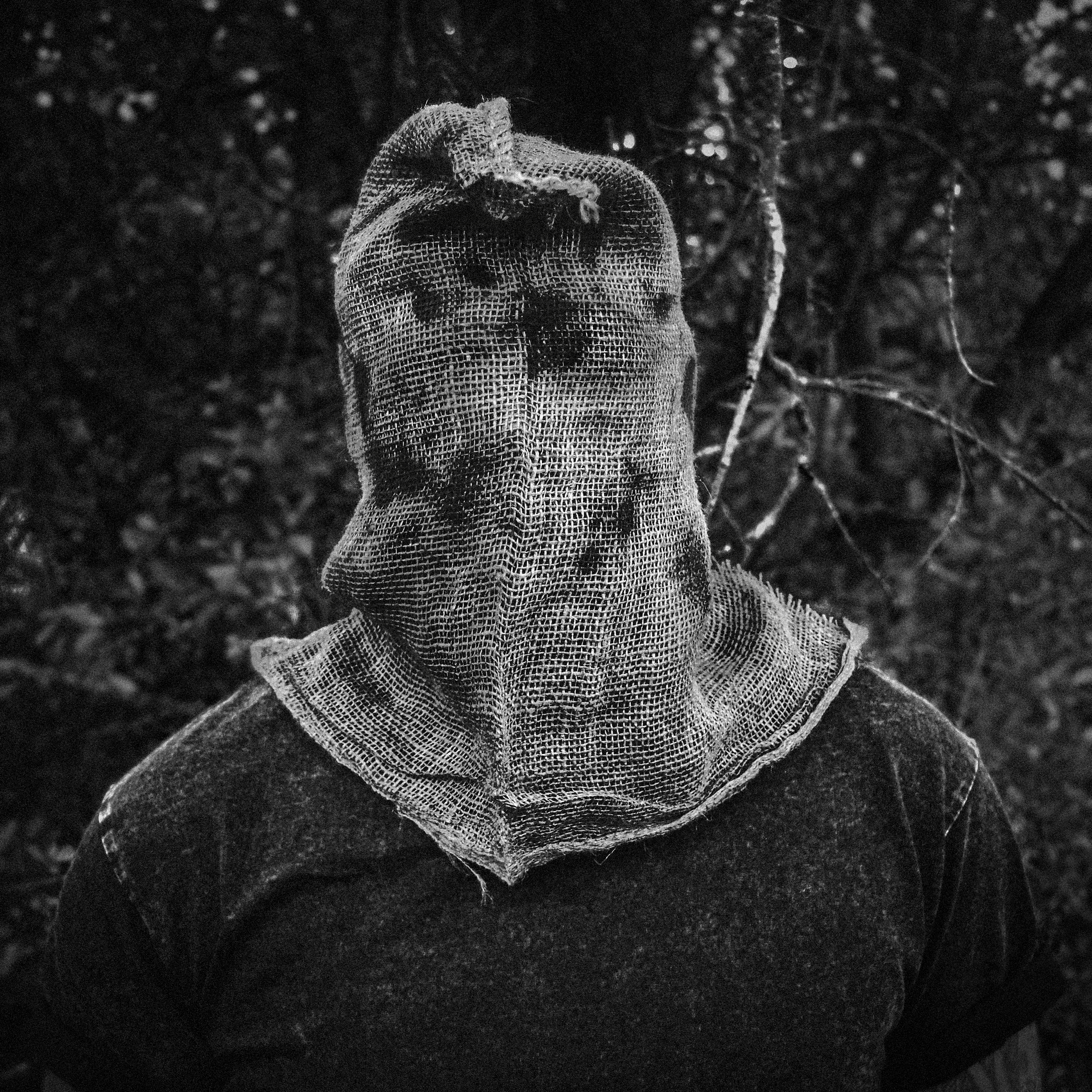 Head Cloud - Imposter: a black and white photo of a man wearing a mask