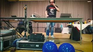 a man standing in front of a table with a microphone