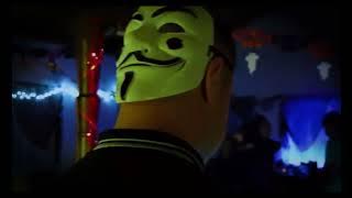 a man in a mask wearing a green v for vendetta mask