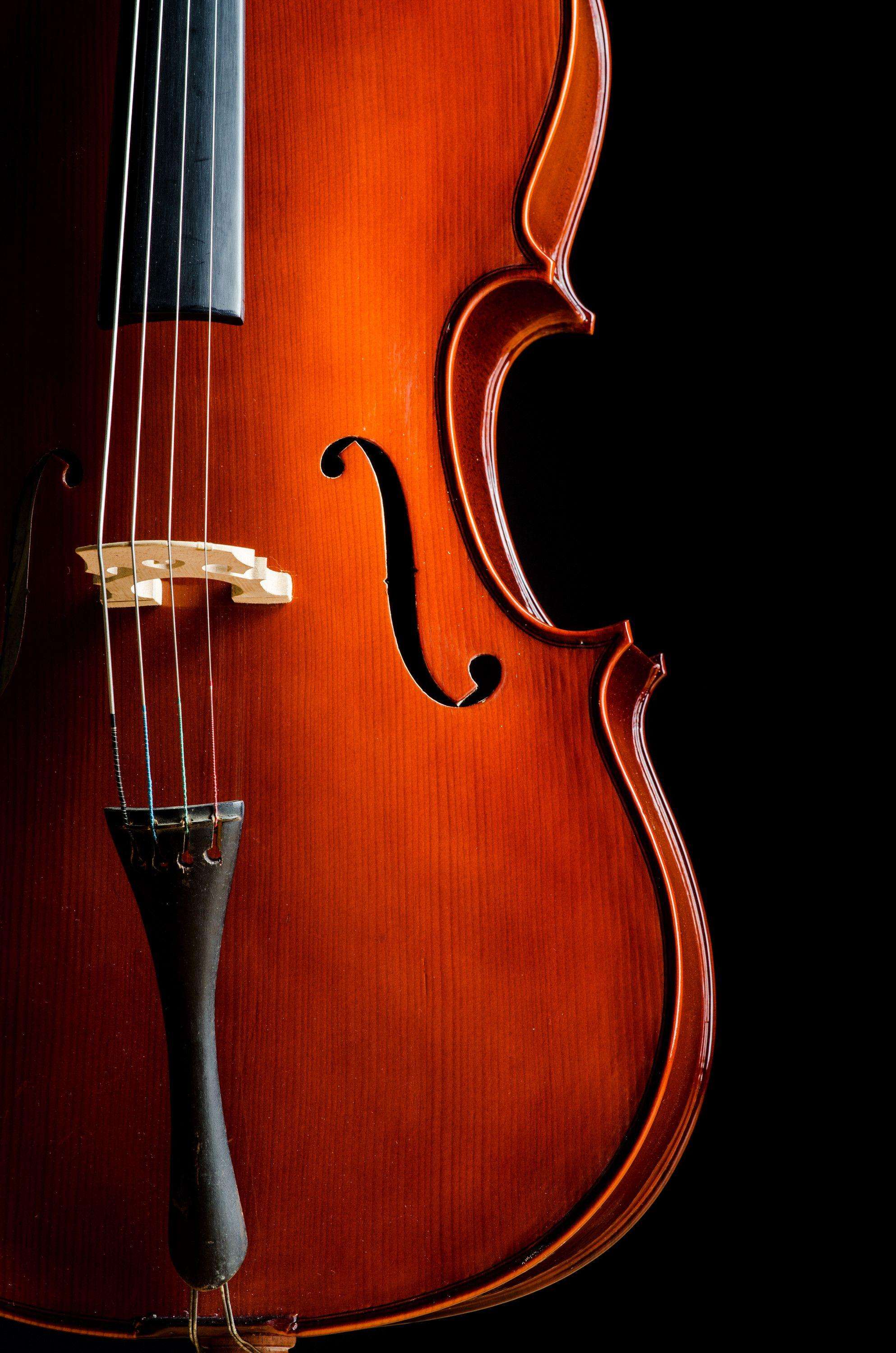 a close up of a cello on a black background