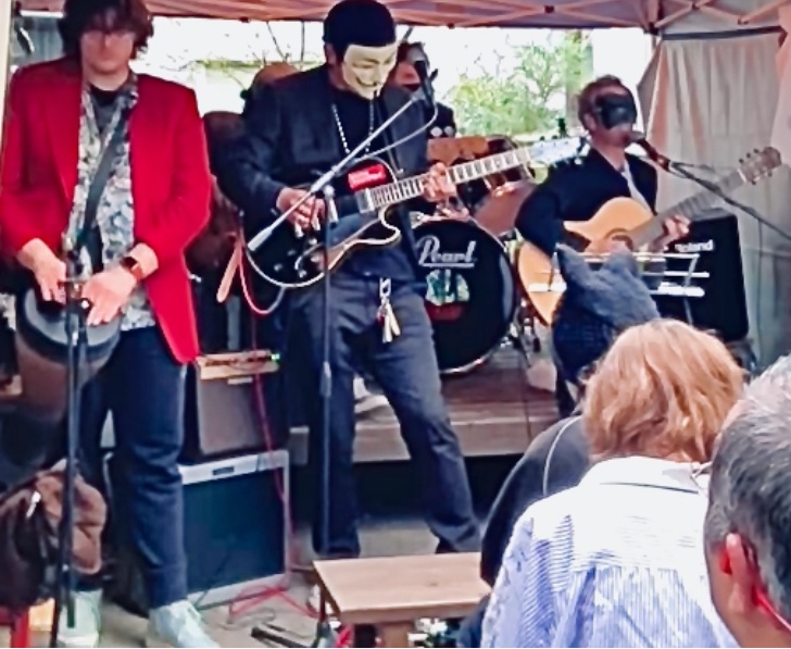 a group of people playing music in a tent