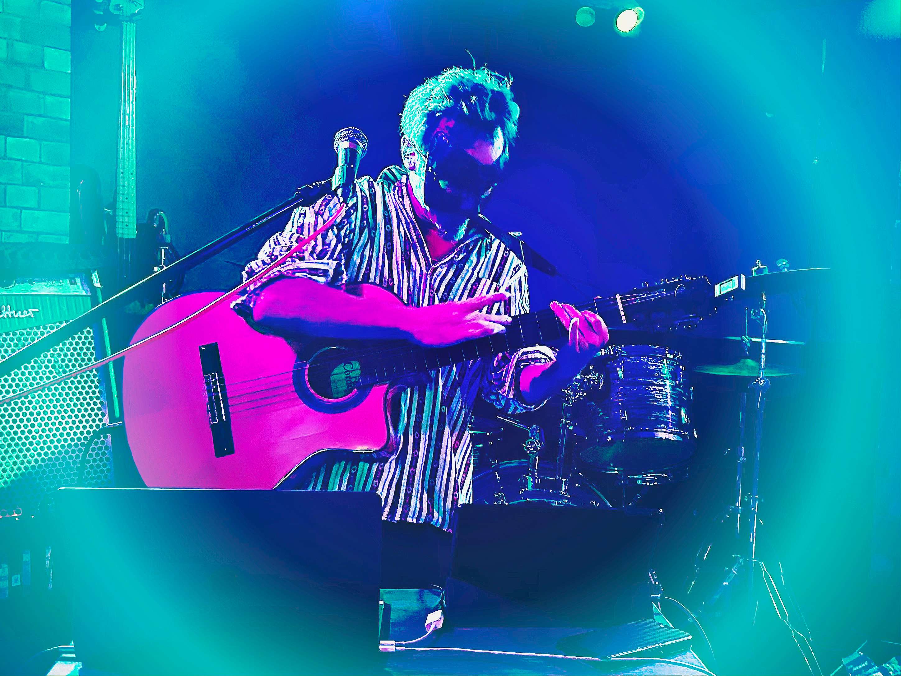 a man playing an acoustic guitar