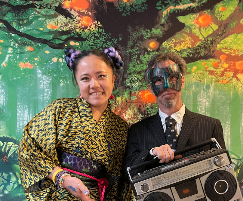 a man and a woman posing for a photo with a boombox